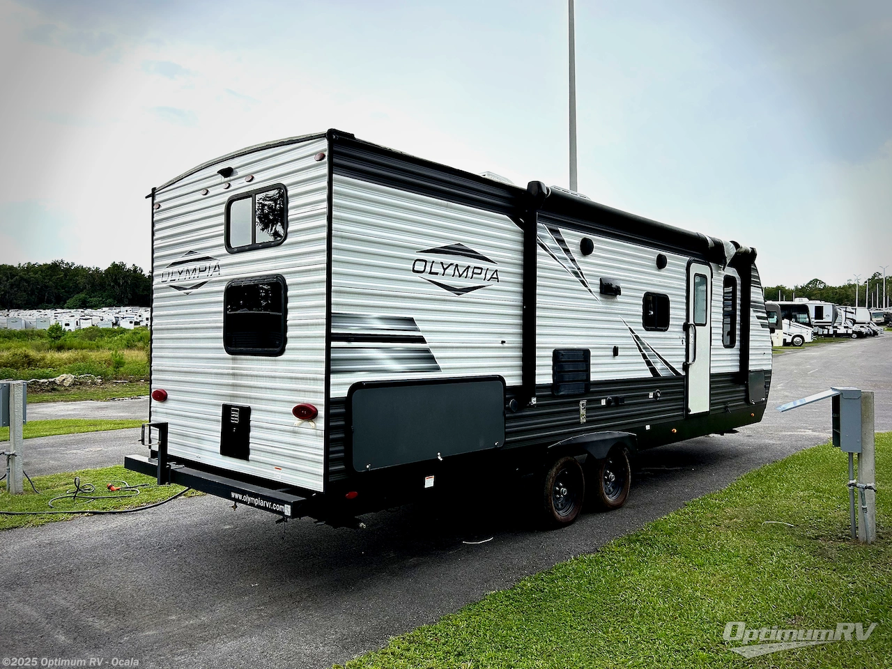 Call now about this 2021 Olympia Olympia 26BHS! 2021 Olympia Olympia 26BHS - Used Travel Trailer For Sale by Optimum RV - Ocala in Ocala, Florida features Slideout, Awning