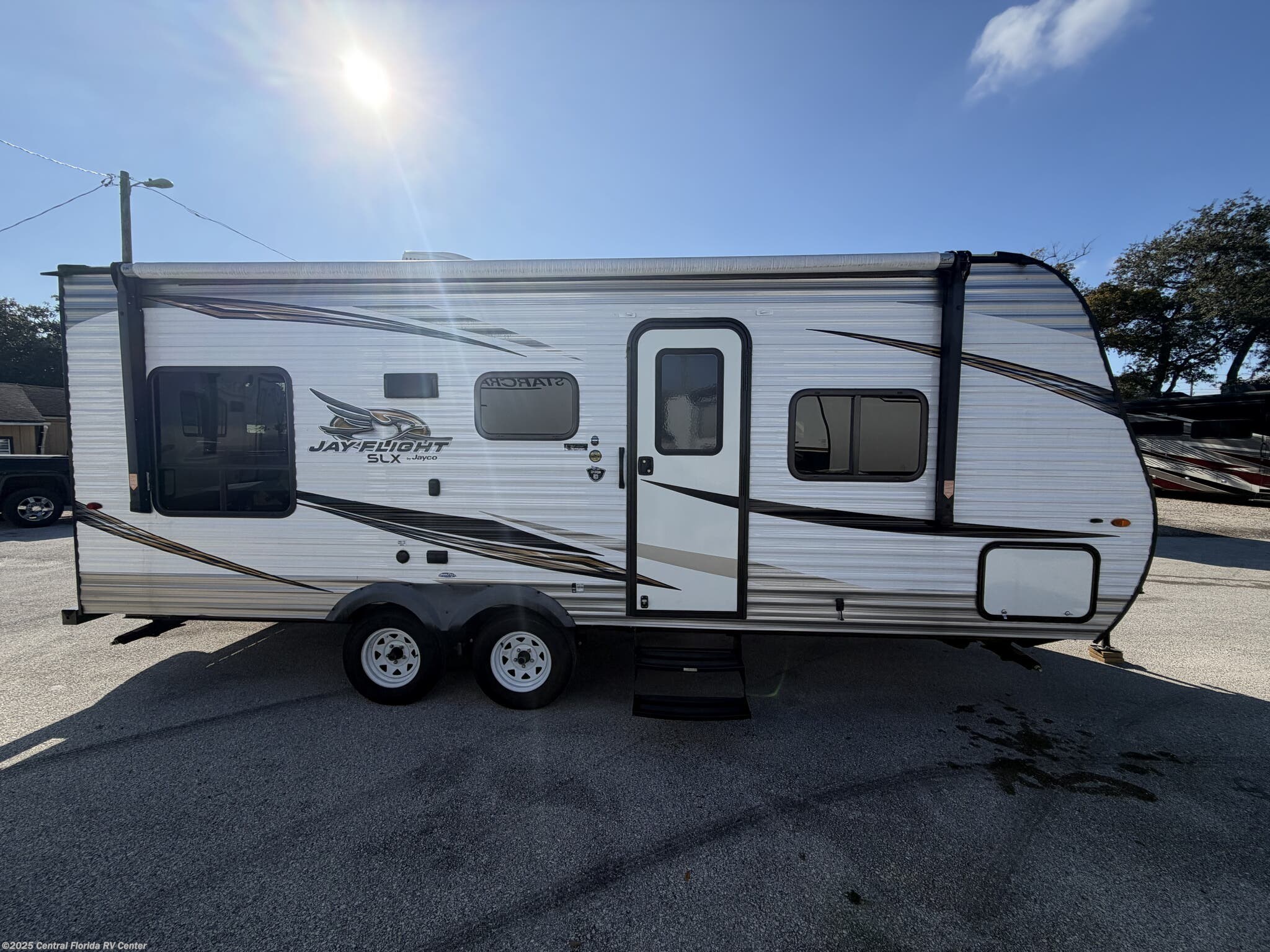 Call now about this 2019 Jayco Jay Flight SLX 212QB! 2019 Jayco Jay Flight SLX 212QB - Used Travel Trailer For Sale by Central Florida RV Center in Apopka, Florida features Leveling Jacks, DVD Player, Queen Bed, TV Antenna, 30 Amp Service