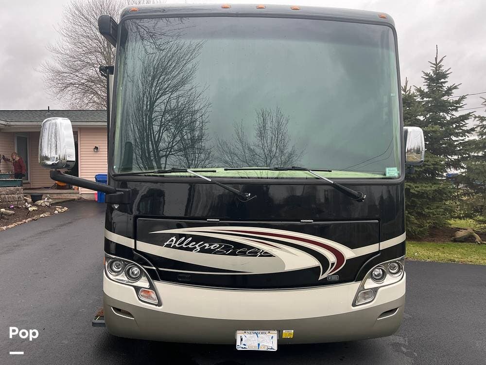 Call now about this 2013 Tiffin Allegro Breeze 32BR! 2013 Tiffin Allegro Breeze 32BR - Used Diesel Pusher For Sale by Pop RVs in Lockport, New York features Leveling Jacks, Air Conditioning, Slideout, Awning, Generator