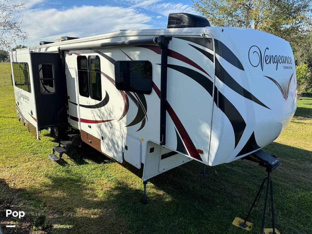 Call now about this 2017 Forest River Vengeance 39R12 Touring Edition! 2017 Forest River Vengeance 39R12 Touring Edition - Used Toy Hauler For Sale by Pop RVs in Lakeland, Florida features Leveling Jacks, Air Conditioning, Generator, Slideout, Awning