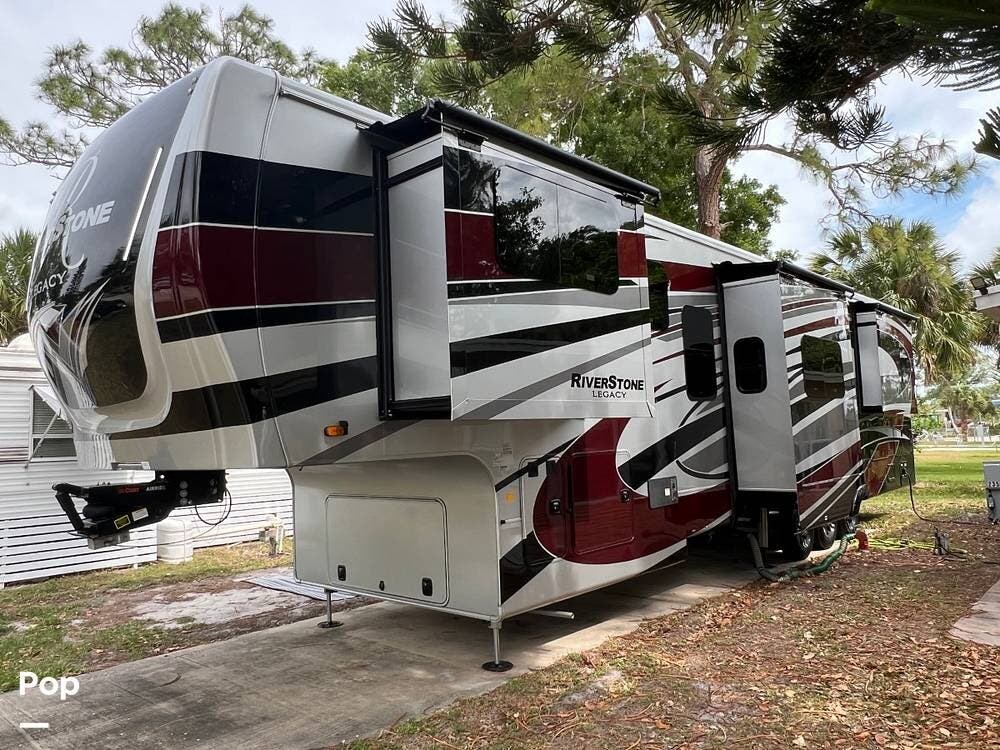 Call now about this 2024 Forest River RiverStone Legacy 42FSKG! 2024 Forest River RiverStone Legacy 42FSKG - Used Toy Hauler For Sale by Pop RVs in Vero Beach, Florida features Generator, Slideout, Leveling Jacks, Awning, Air Conditioning