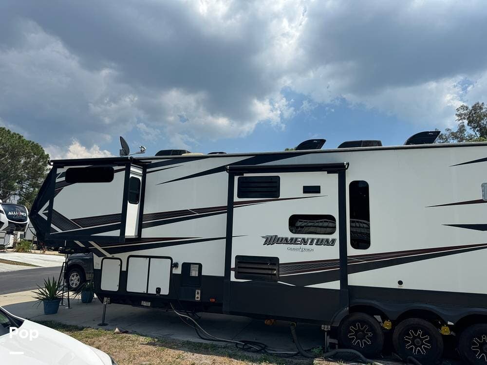 Call now about this 2018 Grand Design Momentum 397TH! 2018 Grand Design Momentum 397TH - Used Toy Hauler For Sale by Pop RVs in Bradenton, Florida features Air Conditioning, Generator, Leveling Jacks, Slideout, Awning