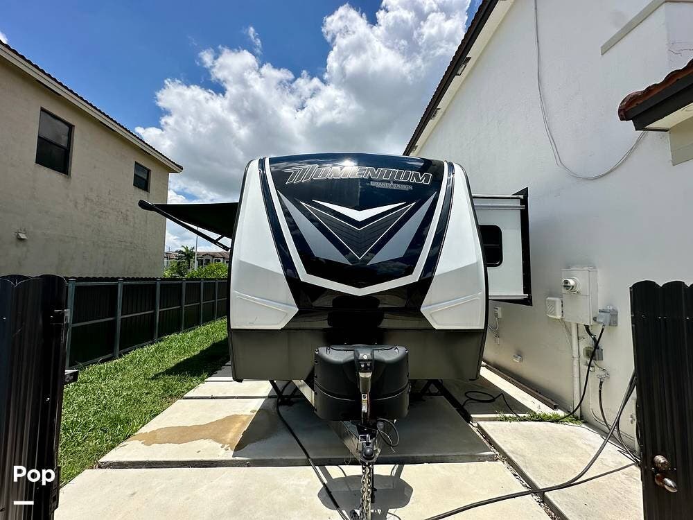 Call now about this 2022 Grand Design Momentum 23G! 2022 Grand Design Momentum 23G - Used Toy Hauler For Sale by Pop RVs in Homestead, Florida features Awning, Slideout, Air Conditioning, Leveling Jacks