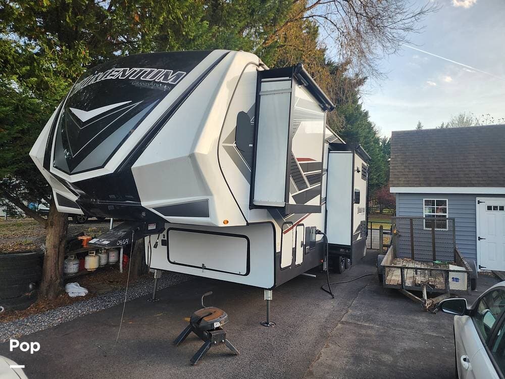 Call now about this 2022 Grand Design Momentum 351MS! 2022 Grand Design Momentum 351MS - Used Toy Hauler For Sale by Pop RVs in Chestertown, Maryland features Slideout, Leveling Jacks, Awning, Air Conditioning, Generator