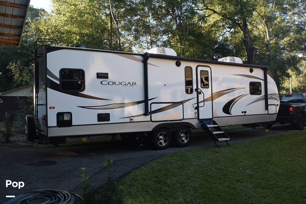 Call now about this 2021 Keystone Cougar 30RKD! 2021 Keystone Cougar 30RKD - Used Travel Trailer For Sale by Pop RVs in Pace, Florida features Leveling Jacks, Slideout, Awning, Air Conditioning