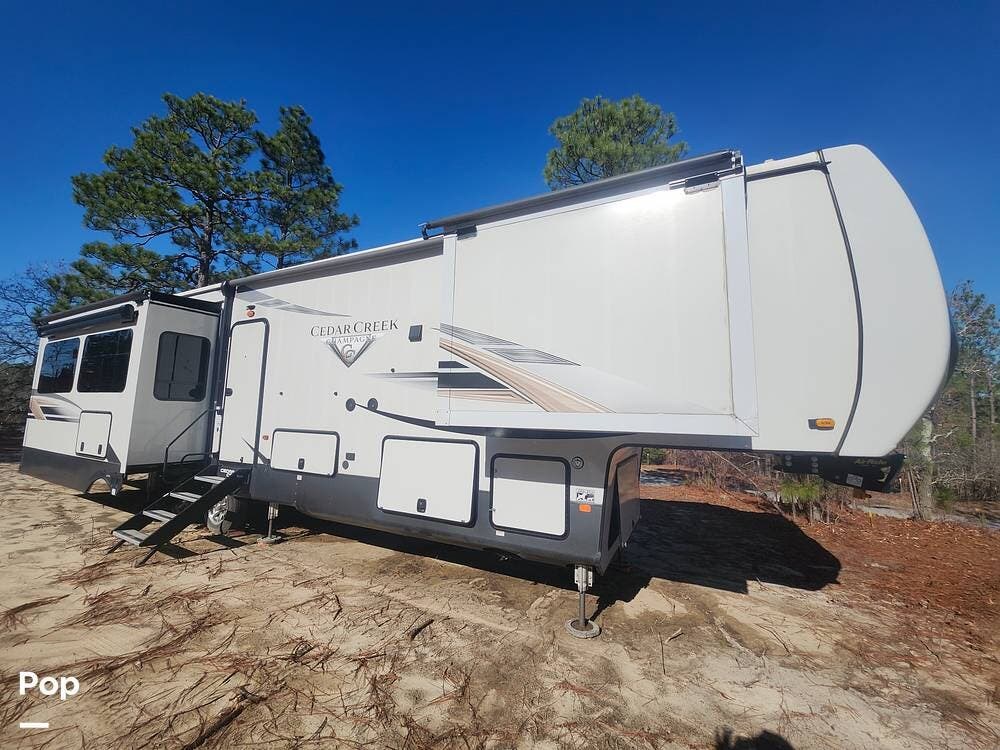 Call now about this 2021 Forest River Cedar Creek Champagne 38EBS! 2021 Forest River Cedar Creek Champagne 38EBS - Used Fifth Wheel For Sale by Pop RVs in Lexington, South Carolina features Awning, Leveling Jacks, Slideout, Air Conditioning