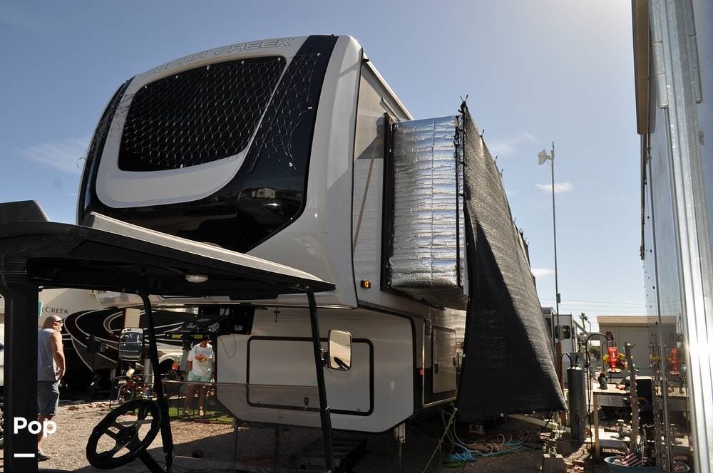 Call now about this 2021 Forest River Cedar Creek 385TH! 2021 Forest River Cedar Creek 385TH - Used Toy Hauler For Sale by Pop RVs in Bullhead City, Arizona features Leveling Jacks, Air Conditioning, Slideout, Awning