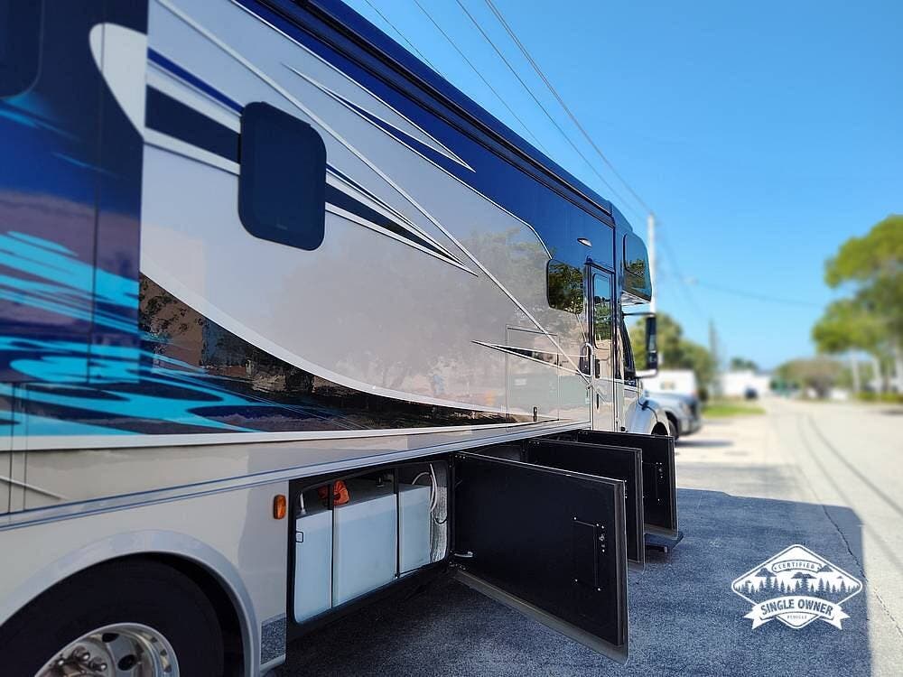 Call now about this 2022 Dynamax Corp DynaQuest XL 37RB! 2022 Dynamax Corp DynaQuest XL 37RB - Used Super C For Sale by Pop RVs in Naples, Florida features Slideout, Generator, Air Conditioning, Awning, Leveling Jacks