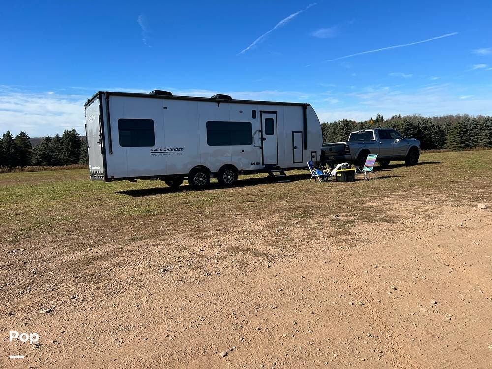 Call now about this 2021 ATC Game Changer ATC 2823 Pro! 2021 ATC Game Changer ATC 2823 Pro - Used Toy Hauler For Sale by Pop RVs in Pittsford, New York features Generator, Leveling Jacks, Air Conditioning, Awning