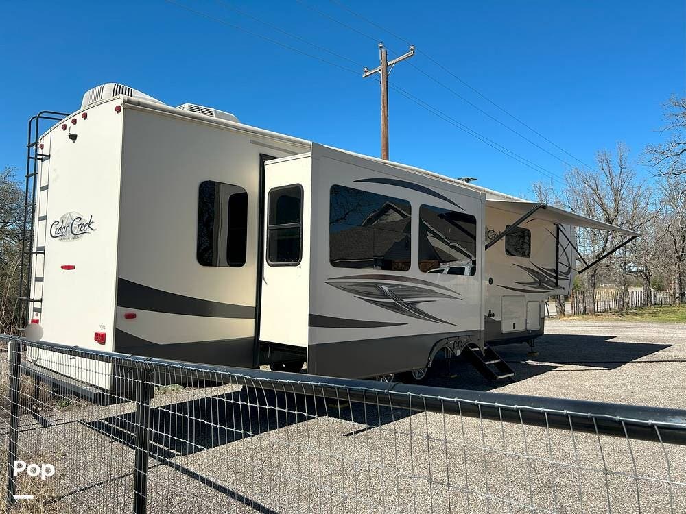 Call now about this 2019 Forest River Cedar Creek 38DBRK! 2019 Forest River Cedar Creek 38DBRK - Used Fifth Wheel For Sale by Pop RVs in Weatherford, Texas features Slideout, Awning, Air Conditioning, Leveling Jacks