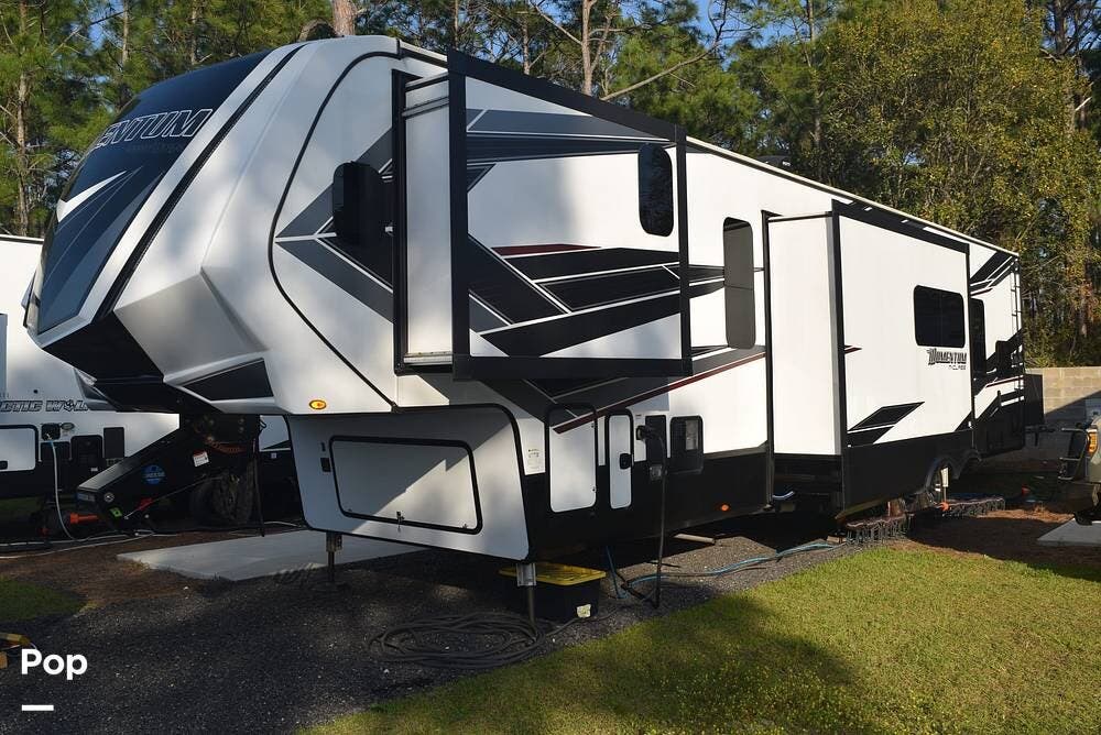 Call now about this 2021 Grand Design Momentum 395MS! 2021 Grand Design Momentum 395MS - Used Toy Hauler For Sale by Pop RVs in Mobile, Alabama features Slideout, Awning, Generator, Leveling Jacks, Air Conditioning