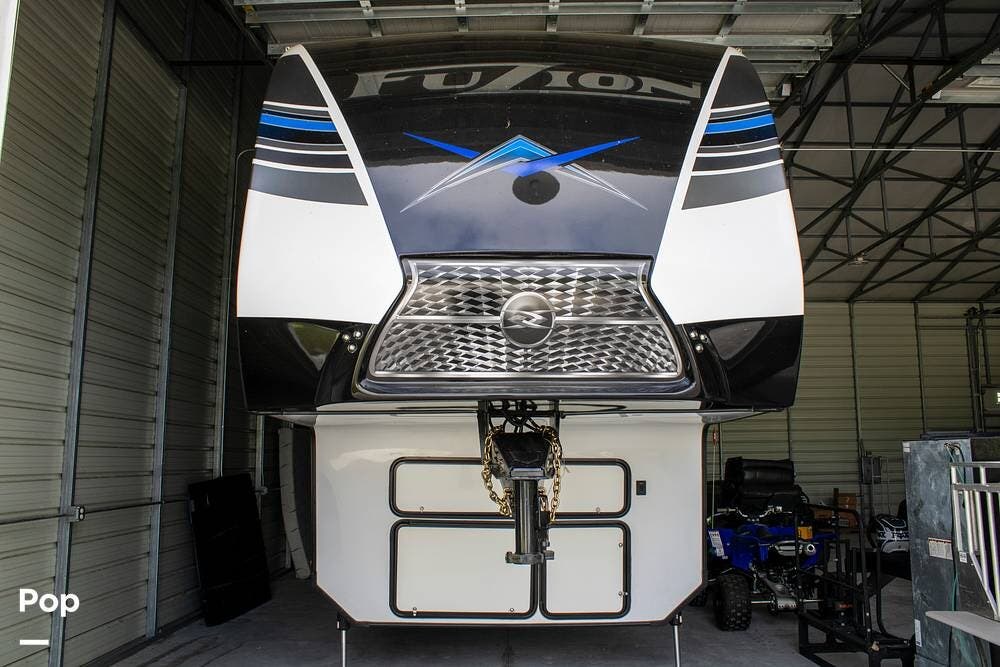 Call now about this 2021 Keystone Fuzion 419! 2021 Keystone Fuzion 419 - Used Toy Hauler For Sale by Pop RVs in Lakeland, Florida features Leveling Jacks, Awning, Generator, Air Conditioning, Slideout