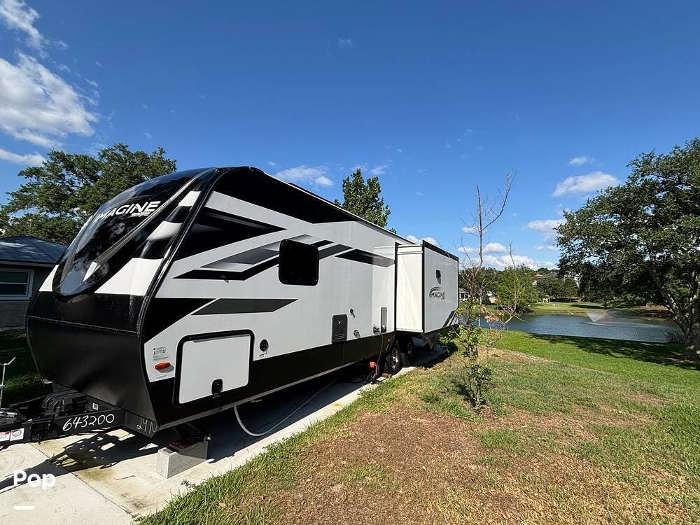 Call now about this 2023 Grand Design Imagine 2970RL! 2023 Grand Design Imagine 2970RL - Used Travel Trailer For Sale by Pop RVs in Montverde, Florida features Slideout, Leveling Jacks, Air Conditioning, Awning