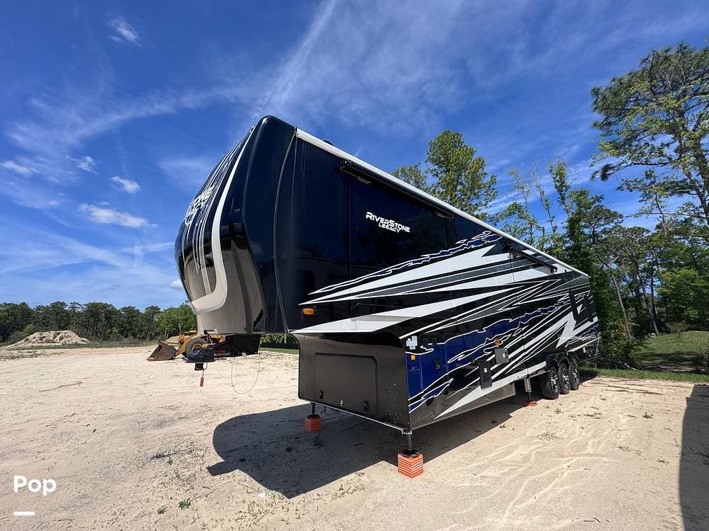 Call now about this 2023 Forest River RiverStone 45BATH! 2023 Forest River RiverStone 45BATH - Used Toy Hauler For Sale by Pop RVs in Crystal River, Florida features Generator, Air Conditioning, Leveling Jacks, Awning, Slideout