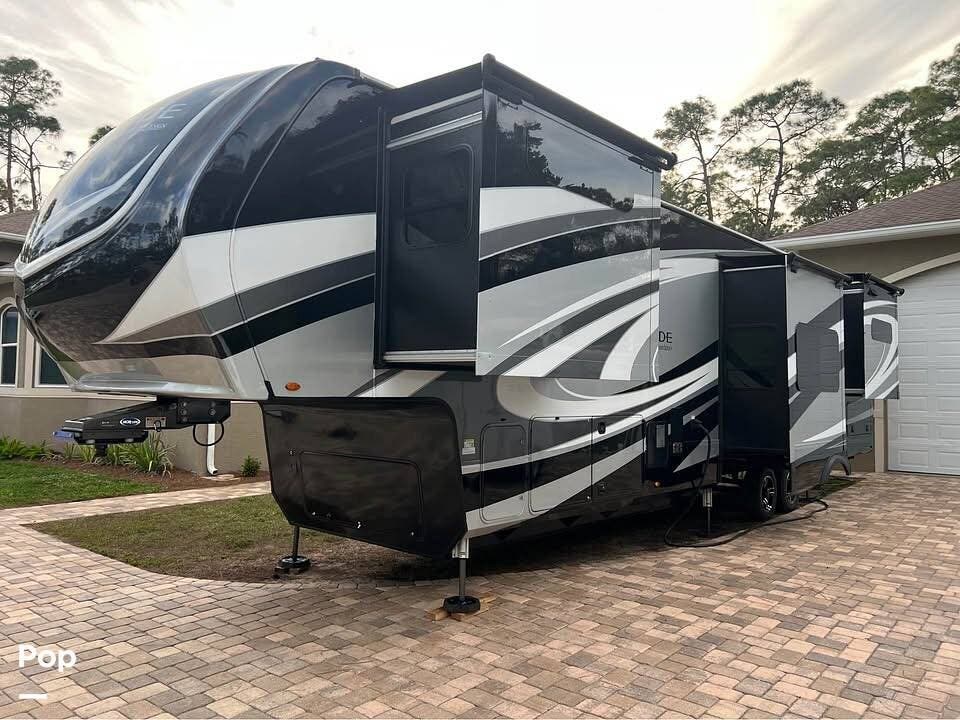 Call now about this 2022 Grand Design Solitude 390RKR! 2022 Grand Design Solitude 390RKR - Used Fifth Wheel For Sale by Pop RVs in Bonita Springs, Florida features Slideout, Leveling Jacks, Awning, Air Conditioning