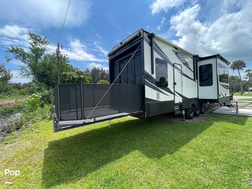 Call now about this 2018 Grand Design Momentum 388M! 2018 Grand Design Momentum 388M - Used Toy Hauler For Sale by Pop RVs in Sebastian, Florida features Slideout, Awning, Generator, Leveling Jacks, Air Conditioning