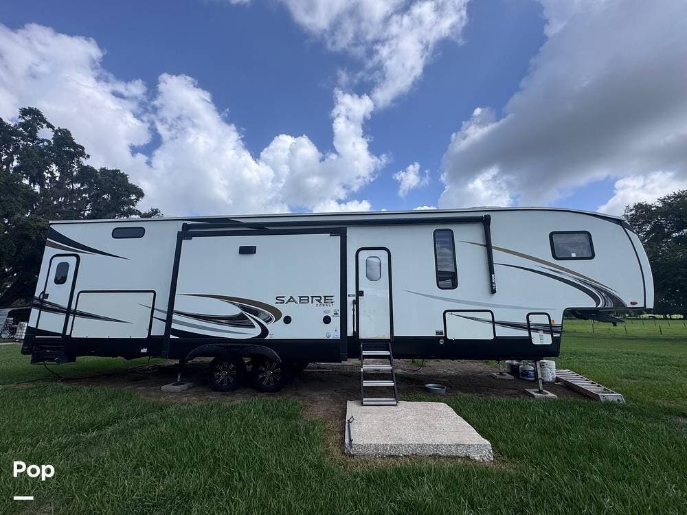 Call now about this 2021 Forest River Sabre Cobalt 38DBQ! 2021 Forest River Sabre Cobalt 38DBQ - Used Fifth Wheel For Sale by Pop RVs in Webster, Florida features Air Conditioning, Awning, Slideout, Leveling Jacks