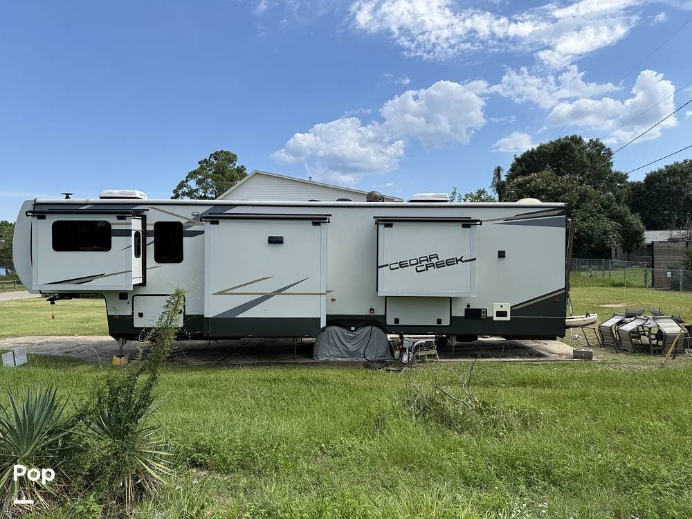 Call now about this 2021 Forest River Cedar Creek 371FL! 2021 Forest River Cedar Creek 371FL - Used Fifth Wheel For Sale by Pop RVs in Pensacola, Florida features Awning, Air Conditioning, Leveling Jacks, Slideout