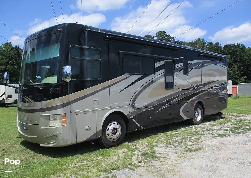 Call now about this 2015 Tiffin Allegro Red 33AA! 2015 Tiffin Allegro Red 33AA - Used Diesel Pusher For Sale by Pop RVs in Palm Coast, Florida features Slideout, Awning, Leveling Jacks, Air Conditioning, Generator