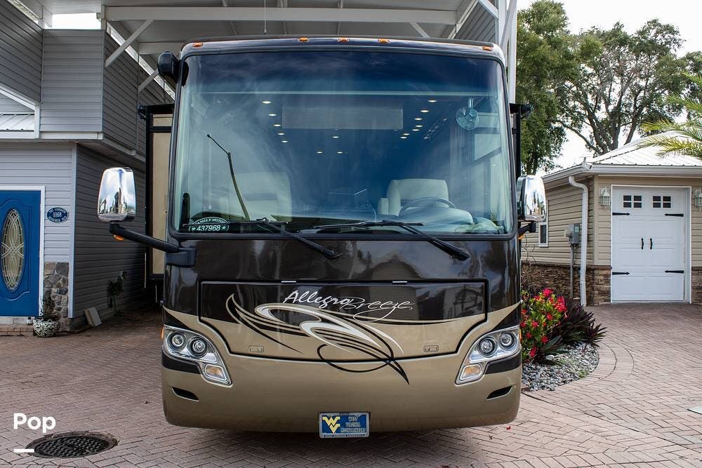 Call now about this 2012 Tiffin Allegro Breeze 32BR! 2012 Tiffin Allegro Breeze 32BR - Used Diesel Pusher For Sale by Pop RVs in Davenport, Florida features Leveling Jacks, Slideout, Air Conditioning, Awning, Generator