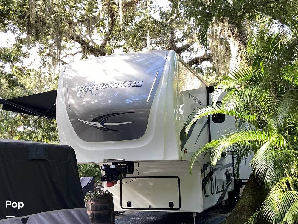 Call now about this 2024 Forest River RiverStone 39RKFB! 2024 Forest River RiverStone 39RKFB - Used Fifth Wheel For Sale by Pop RVs in River Ranch, Florida features Leveling Jacks, Awning, Slideout, Air Conditioning