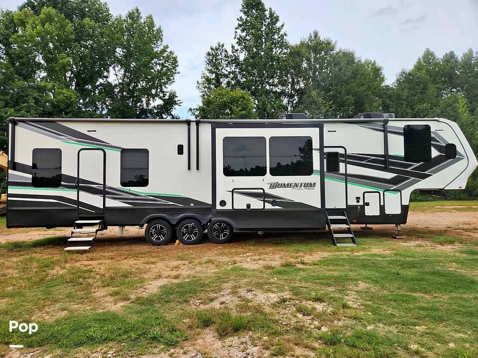 Call now about this 2021 Grand Design Momentum 398M! 2021 Grand Design Momentum 398M - Used Toy Hauler For Sale by Pop RVs in Blacksburg, South Carolina features Generator, Air Conditioning, Slideout, Awning, Leveling Jacks