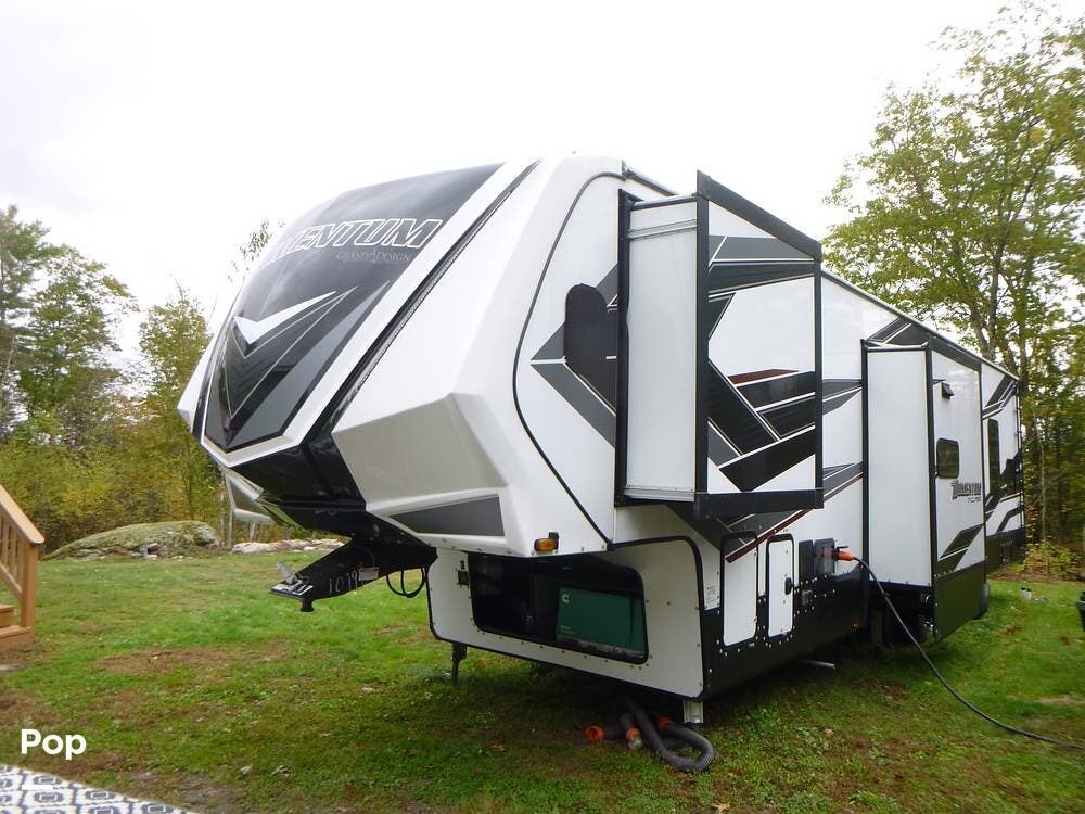 Call now about this 2022 Grand Design Momentum 381M-R! 2022 Grand Design Momentum 381M-R - Used Toy Hauler For Sale by Pop RVs in Richmond, New Hampshire features Awning, Generator, Slideout, Air Conditioning, Leveling Jacks