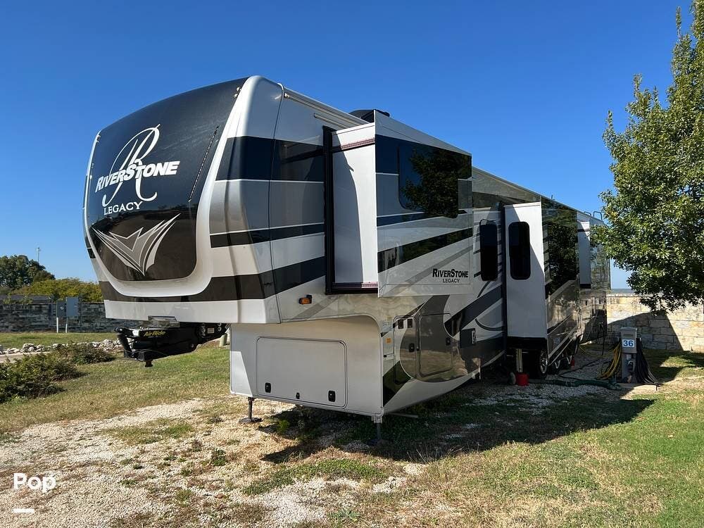 Call now about this 2021 Forest River RiverStone Legacy 39FKTH! 2021 Forest River RiverStone Legacy 39FKTH - Used Toy Hauler For Sale by Pop RVs in Jarrell, Texas features Generator, Awning, Air Conditioning, Slideout, Leveling Jacks