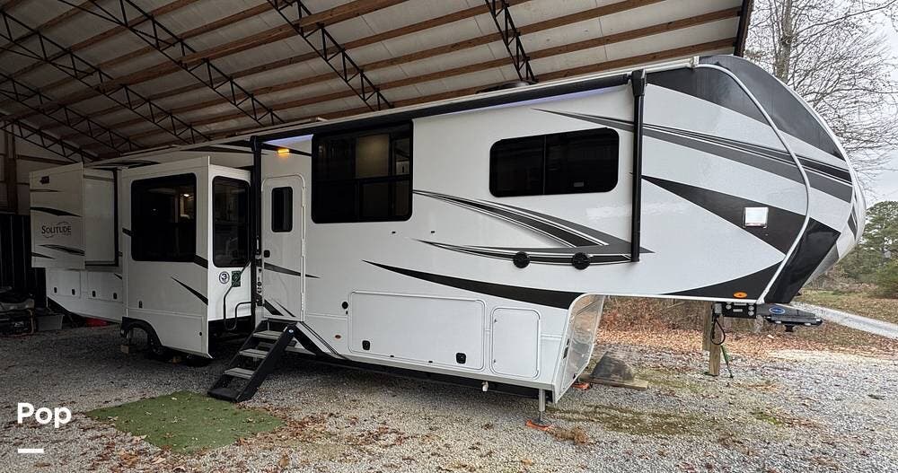 Call now about this 2024 Grand Design Solitude 390RK! 2024 Grand Design Solitude 390RK - Used Fifth Wheel For Sale by Pop RVs in Fort Payne, Alabama features Slideout, Air Conditioning, Awning, Leveling Jacks