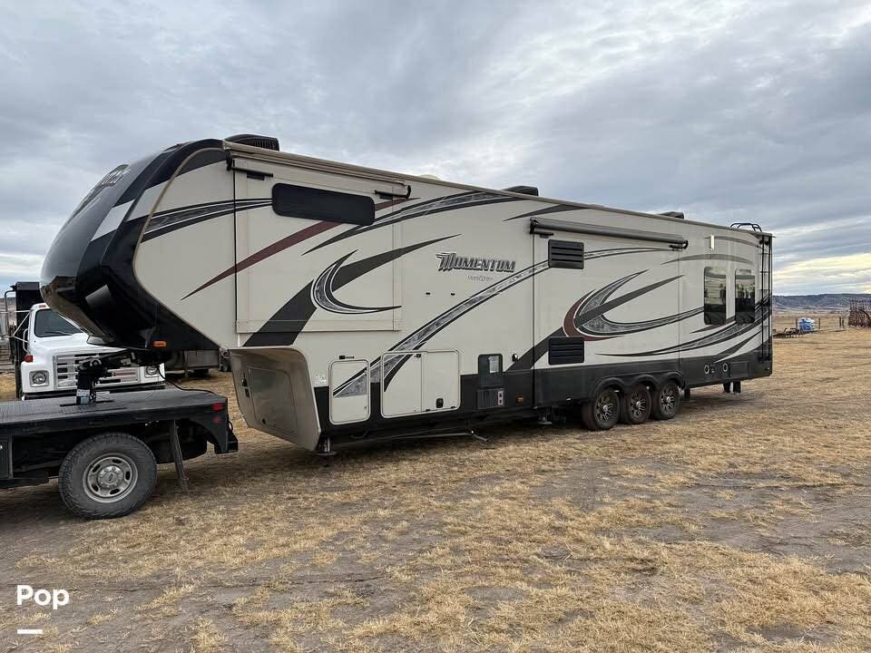 Call now about this 2015 Grand Design Momentum 380TH! 2015 Grand Design Momentum 380TH - Used Toy Hauler For Sale by Pop RVs in Twin Bridges, Montana features Air Conditioning, Awning, Leveling Jacks, Generator, Slideout