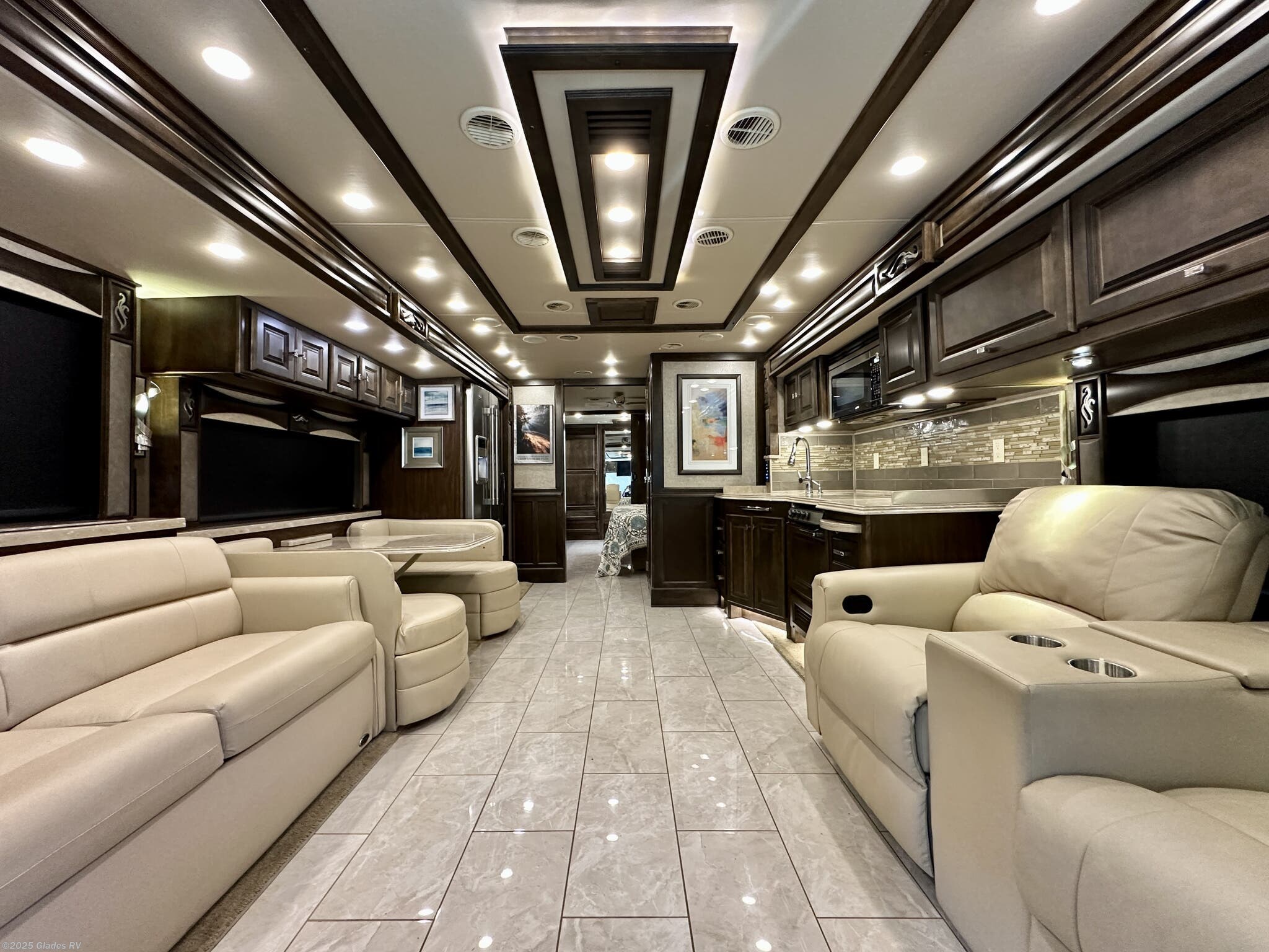 Call now about this 2018 Tiffin Phaeton 40 IH! 2018 Tiffin Phaeton 40 IH - Used Diesel Pusher For Sale by Glades RV in Fort Myers, Florida features Televator TV, Pantry, Automatic Leveling Jacks, Bath & 1/2, Built-In Safe