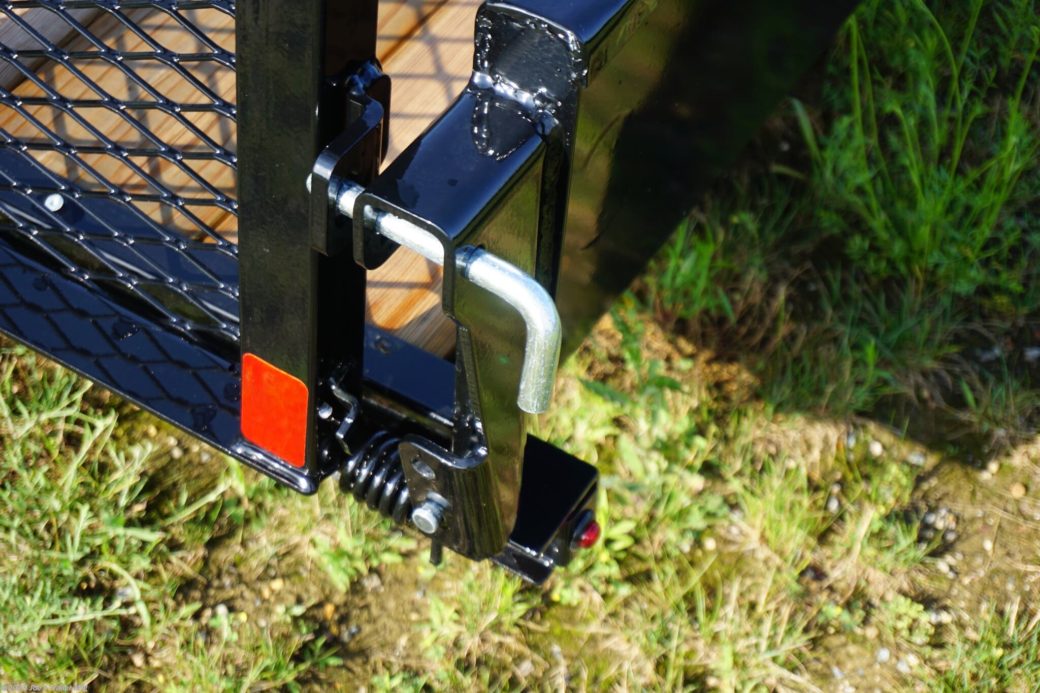 82x20 Tandem Solid Side, 12-Gauge Steel Frame, Steel Angle Crossmembers, 12-Gauge Steel Sides, 15" Tall, 4" Steel Channel Tongue, A-Frame Posi-lock Coupler, Dual Safety Chains and Hooks, 2K Rated Set-Back Jack with Foot, 2x8 Treated, #1 Grade Wood Decking, Welded Front Board Retainer, Welded Rear End Cap, 50" Spring Assisted Gate, Grab Handle, Steel Tread Plate Fenders, Spring Suspension, Easy Lube Hubs, Radial Tires, Black Steel Wheels, Enclosed Sealed Wiring Harness, Full LED Lighting, DOT Compliant Lighting, D-Rings Tie Downs, Spare Tire Mount, Load Angle, Ramp Length, Load Angle: 22°, Ramp Length: 50", ramp pivot point, heavy-duty trailer, utility trailer, equipment trailer, tandem axle trailer, solid side trailer, durable trailer, trailer safety features, easy maintenance trailer, wood decking trailer, radial tire trailer, LED lighting trailer, steel frame trailer, spring suspension trailer, A-frame coupler, safety chains, set-back jack, treated wood decking, spring assisted gate,