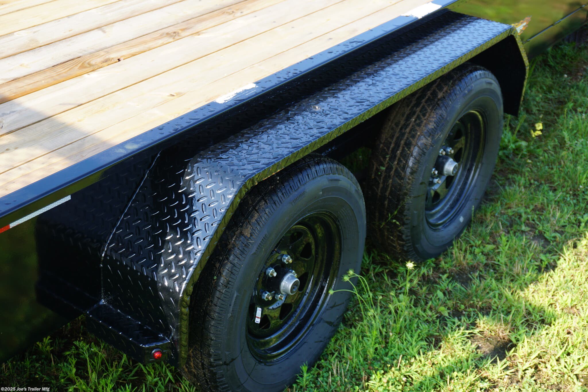 82x20 Tandem Solid Side, 12-Gauge Steel Frame, Steel Angle Crossmembers, 12-Gauge Steel Sides, 15" Tall, 4" Steel Channel Tongue, A-Frame Posi-lock Coupler, Dual Safety Chains and Hooks, 2K Rated Set-Back Jack with Foot, 2x8 Treated, #1 Grade Wood Decking, Welded Front Board Retainer, Welded Rear End Cap, 50" Spring Assisted Gate, Grab Handle, Steel Tread Plate Fenders, Spring Suspension, Easy Lube Hubs, Radial Tires, Black Steel Wheels, Enclosed Sealed Wiring Harness, Full LED Lighting, DOT Compliant Lighting, D-Rings Tie Downs, Spare Tire Mount, Load Angle, Ramp Length, Load Angle: 22°, Ramp Length: 50", ramp pivot point, heavy-duty trailer, utility trailer, equipment trailer, tandem axle trailer, solid side trailer, durable trailer, trailer safety features, easy maintenance trailer, wood decking trailer, radial tire trailer, LED lighting trailer, steel frame trailer, spring suspension trailer, A-frame coupler, safety chains, set-back jack, treated wood decking, spring assisted gate,