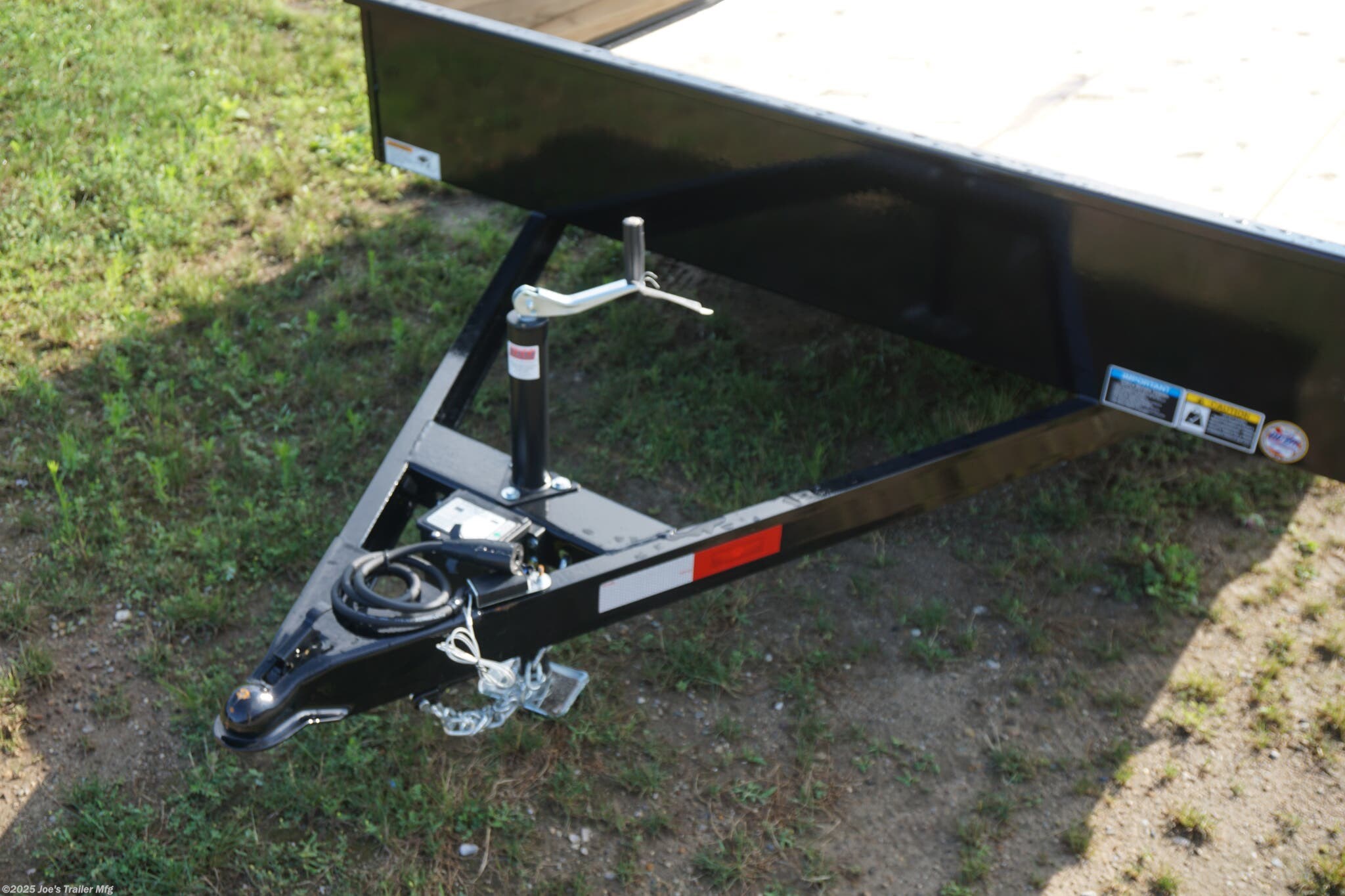 82x20 Tandem Solid Side, 12-Gauge Steel Frame, Steel Angle Crossmembers, 12-Gauge Steel Sides, 15" Tall, 4" Steel Channel Tongue, A-Frame Posi-lock Coupler, Dual Safety Chains and Hooks, 2K Rated Set-Back Jack with Foot, 2x8 Treated, #1 Grade Wood Decking, Welded Front Board Retainer, Welded Rear End Cap, 50" Spring Assisted Gate, Grab Handle, Steel Tread Plate Fenders, Spring Suspension, Easy Lube Hubs, Radial Tires, Black Steel Wheels, Enclosed Sealed Wiring Harness, Full LED Lighting, DOT Compliant Lighting, D-Rings Tie Downs, Spare Tire Mount, Load Angle, Ramp Length, Load Angle: 22°, Ramp Length: 50", ramp pivot point, heavy-duty trailer, utility trailer, equipment trailer, tandem axle trailer, solid side trailer, durable trailer, trailer safety features, easy maintenance trailer, wood decking trailer, radial tire trailer, LED lighting trailer, steel frame trailer, spring suspension trailer, A-frame coupler, safety chains, set-back jack, treated wood decking, spring assisted gate,