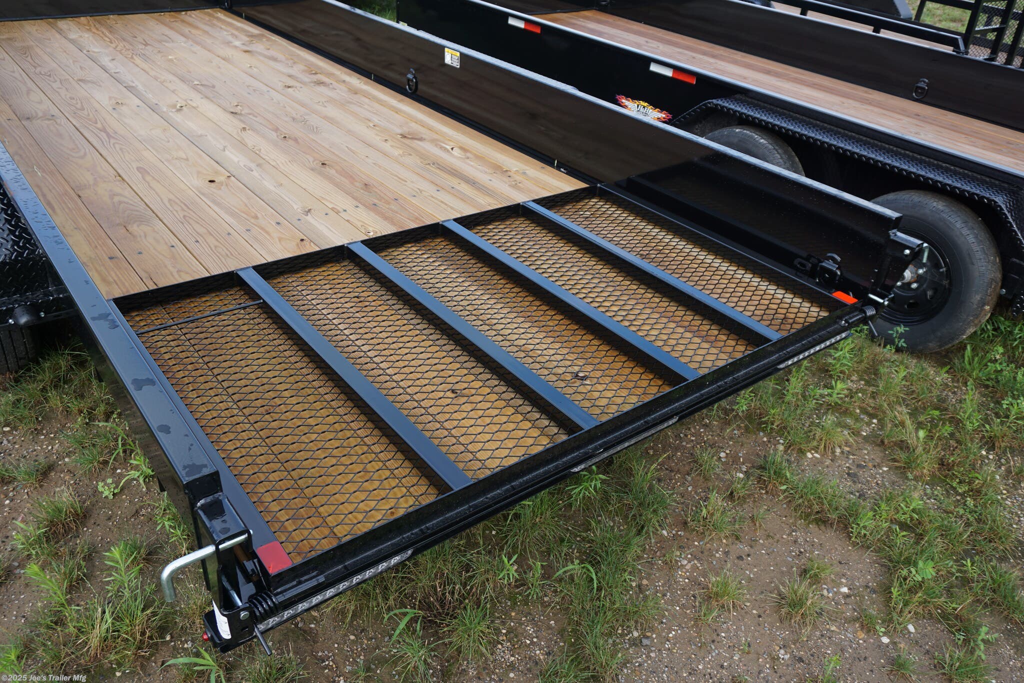 82x20 Tandem Solid Side, 12-Gauge Steel Frame, Steel Angle Crossmembers, 12-Gauge Steel Sides, 15" Tall, 4" Steel Channel Tongue, A-Frame Posi-lock Coupler, Dual Safety Chains and Hooks, 2K Rated Set-Back Jack with Foot, 2x8 Treated, #1 Grade Wood Decking, Welded Front Board Retainer, Welded Rear End Cap, 50" Spring Assisted Gate, Grab Handle, Steel Tread Plate Fenders, Spring Suspension, Easy Lube Hubs, Radial Tires, Black Steel Wheels, Enclosed Sealed Wiring Harness, Full LED Lighting, DOT Compliant Lighting, D-Rings Tie Downs, Spare Tire Mount, Load Angle, Ramp Length, Load Angle: 22°, Ramp Length: 50", ramp pivot point, heavy-duty trailer, utility trailer, equipment trailer, tandem axle trailer, solid side trailer, durable trailer, trailer safety features, easy maintenance trailer, wood decking trailer, radial tire trailer, LED lighting trailer, steel frame trailer, spring suspension trailer, A-frame coupler, safety chains, set-back jack, treated wood decking, spring assisted gate,