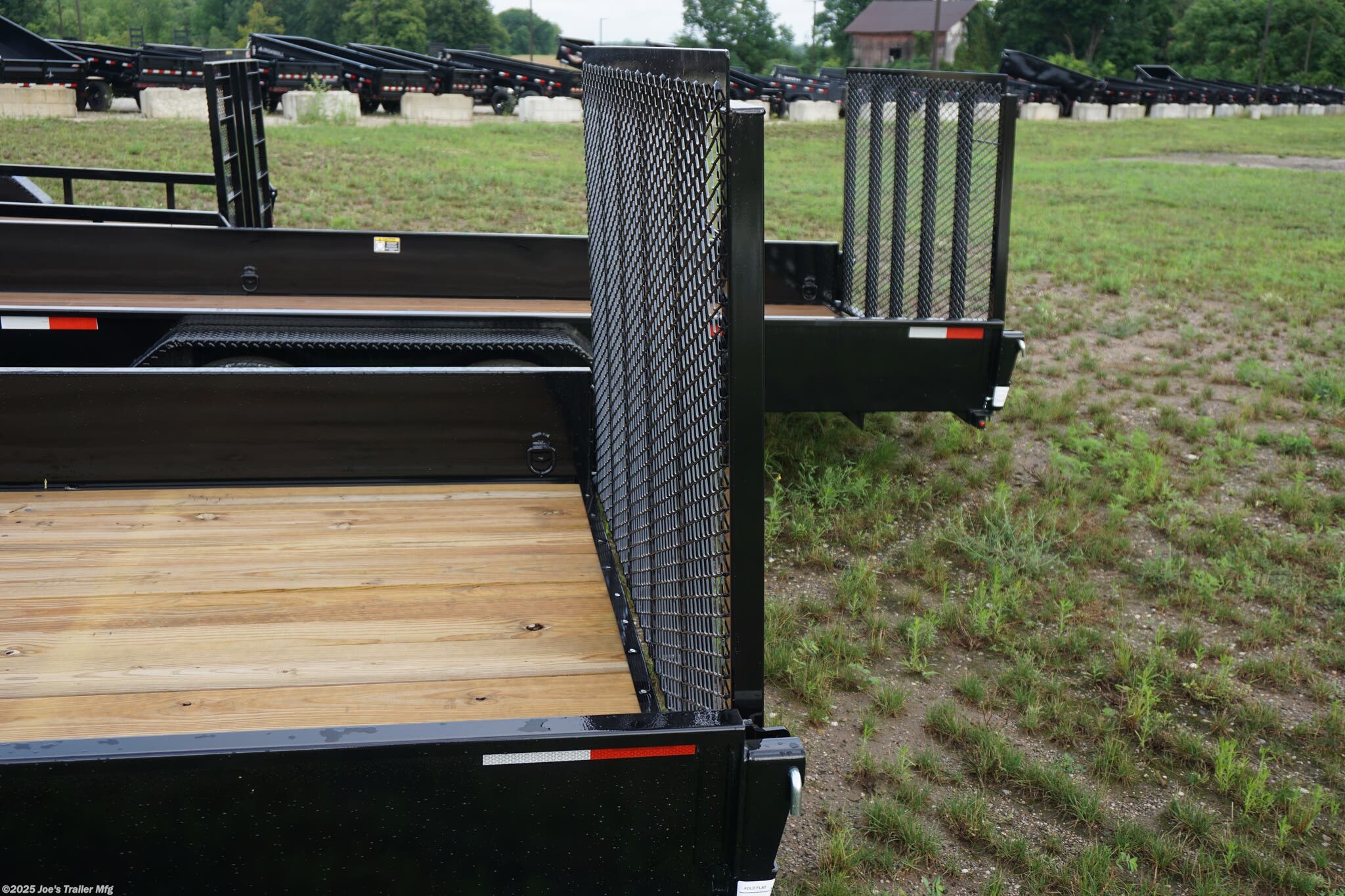 82x20 Tandem Solid Side, 12-Gauge Steel Frame, Steel Angle Crossmembers, 12-Gauge Steel Sides, 15" Tall, 4" Steel Channel Tongue, A-Frame Posi-lock Coupler, Dual Safety Chains and Hooks, 2K Rated Set-Back Jack with Foot, 2x8 Treated, #1 Grade Wood Decking, Welded Front Board Retainer, Welded Rear End Cap, 50" Spring Assisted Gate, Grab Handle, Steel Tread Plate Fenders, Spring Suspension, Easy Lube Hubs, Radial Tires, Black Steel Wheels, Enclosed Sealed Wiring Harness, Full LED Lighting, DOT Compliant Lighting, D-Rings Tie Downs, Spare Tire Mount, Load Angle, Ramp Length, Load Angle: 22°, Ramp Length: 50", ramp pivot point, heavy-duty trailer, utility trailer, equipment trailer, tandem axle trailer, solid side trailer, durable trailer, trailer safety features, easy maintenance trailer, wood decking trailer, radial tire trailer, LED lighting trailer, steel frame trailer, spring suspension trailer, A-frame coupler, safety chains, set-back jack, treated wood decking, spring assisted gate,