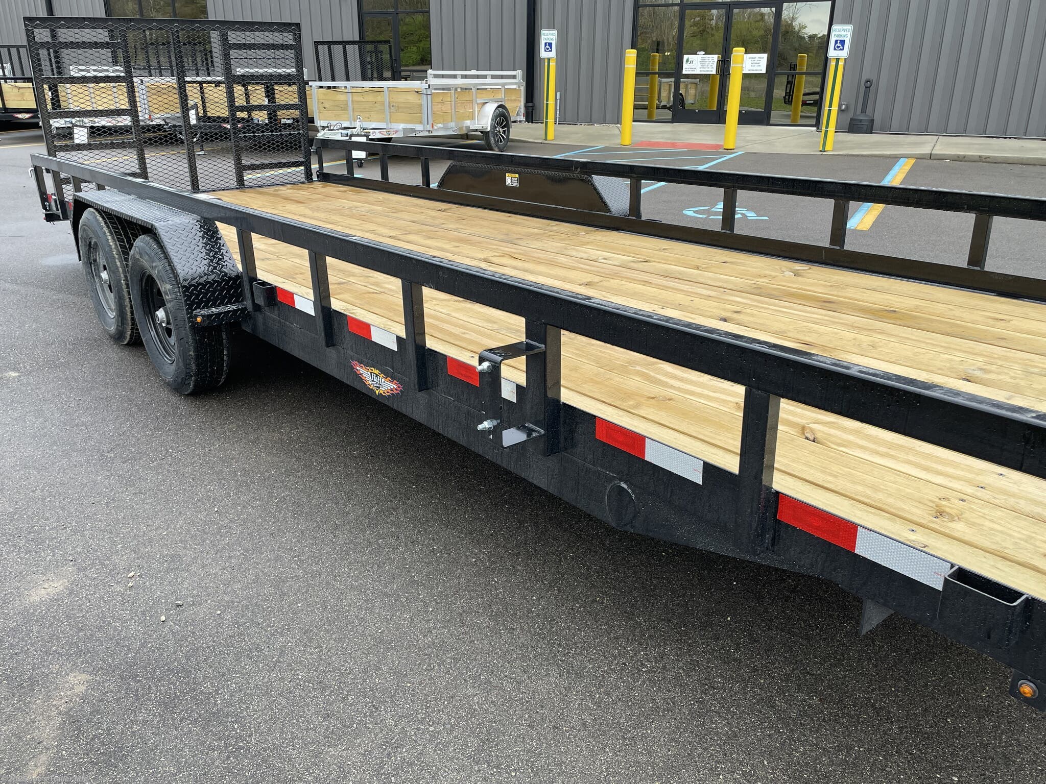 H&H 82" x 22' Heavy Duty Landscape/Utility Trailer, 5" x 3" x 1/4" Steel Angle Frame, 3" x 2" x 3/16" Steel Angle Crossmembers, 5" Steel Channel Tongue, Fully Wrapped, 3" x 2" Steel Tube Top Rail, 2-5/16" A-Frame Posi-Lock Coupler, Dual Safety Chains and Hooks, 7-Way RV-Style Plug, Enclosed Sealed Wiring Harness, 7k Rated Setback Drop Leg Jack, 50" Tall Reinforced Spring Assist Gate, Ladder Style Gate, Steel Formed Tread Plate Fenders, Tandem Spring Brake Suspension, 9900 lb GVWR, Easy Lube Hubs, ST225/75R15 'D' Tires, 15" Black Steel Wheels, Industrial Grade Polymer Finish, 2 x 8 Pressure Treated Pine Decking, Welded Front Board Retainer, Rear End Board Cap, Stake Pockets, Spare Tire Mount, Full LED DOT Compliant Lighting, Heavy Duty Utility Trailer, Landscape Trailer, Steel Angle Frame Trailer, Heavy Duty Trailer, Landscape Utility Trailer, Tandem Axle Utility Trailer, Spring Assist Gate Trailer, Steel Channel Tongue Trailer, Pressure Treated Pine Deck Trailer, Black Steel Wheels Tra