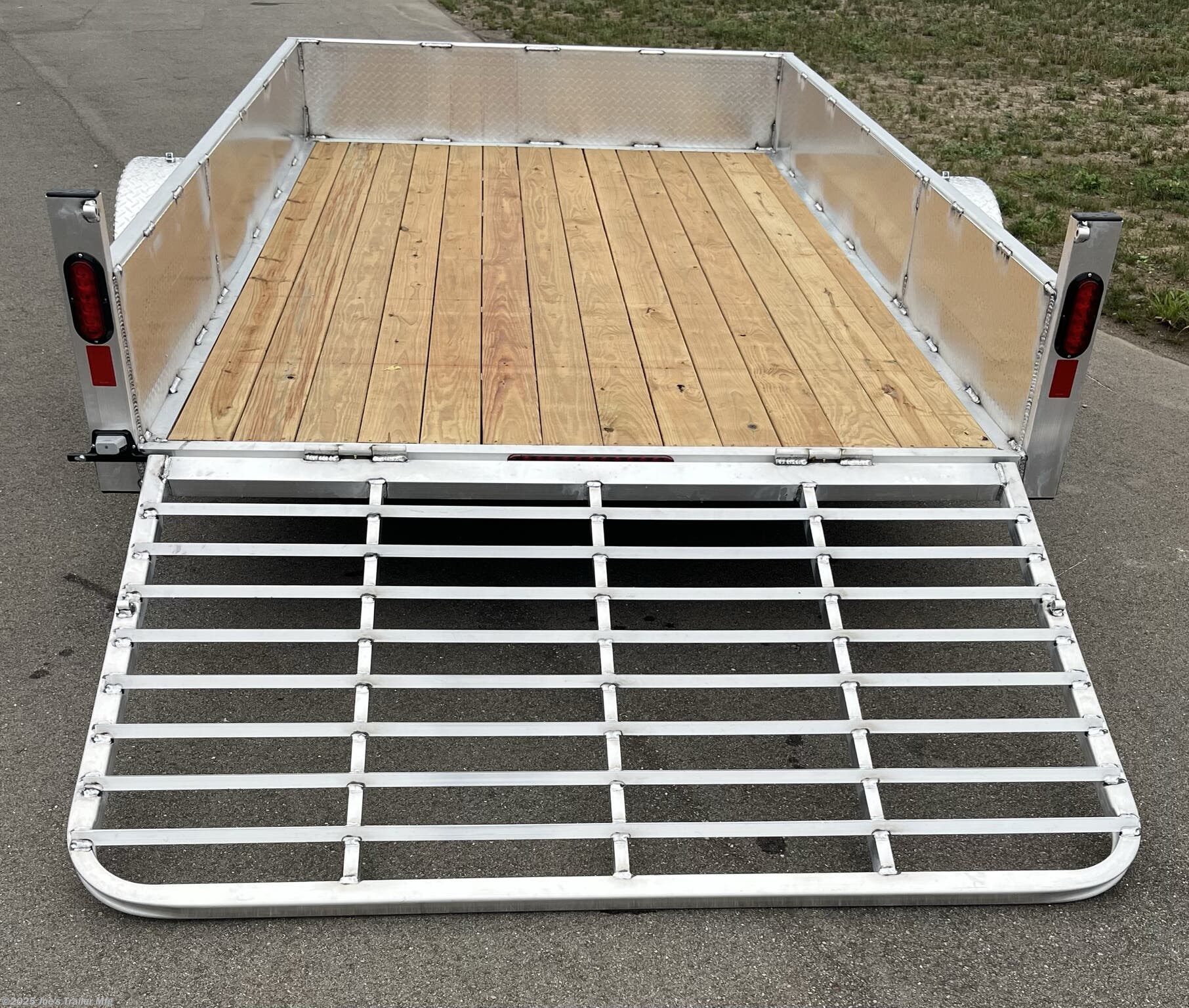 Legend Open Deluxe 7X12 Utility Trailer, 4" Tube Main Frame Utility Trailer, 24" OC Crossmembers Trailer, 15" Side Rails With Skirting, 2" Coupler Trailer, ST205/75R14 Steel Tires Trailer, ATP Fenders Utility Trailer, Treated Wood Decking Trailer, (4) Stake Pockets Utility Trailer, No Brakes Utility Trailer, Load Angle 19° Trailer, Ramp Length 48" Trailer, Ramp Pivot Point Trailer, Heavy Duty Utility Trailer, Durable Utility Trailer, Steel Tires Utility Trailer, Tubular Frame Trailer, Crossmembers Spacing 24" Trailer, Side Rails With Skirting Utility Trailer, Coupler 2" Trailer, Aluminum Fenders Utility Trailer, Wood Decking Treated, Stake Pockets 4 Trailer, Trailer Without Brakes, Load Angle 19 Degrees, Ramp Length 48 Inches, Utility Trailer Specs, Trailer Features, Utility Trailer Specifications, Legend Trailer Features, Deluxe Utility Trailer, Open Utility Trailer
