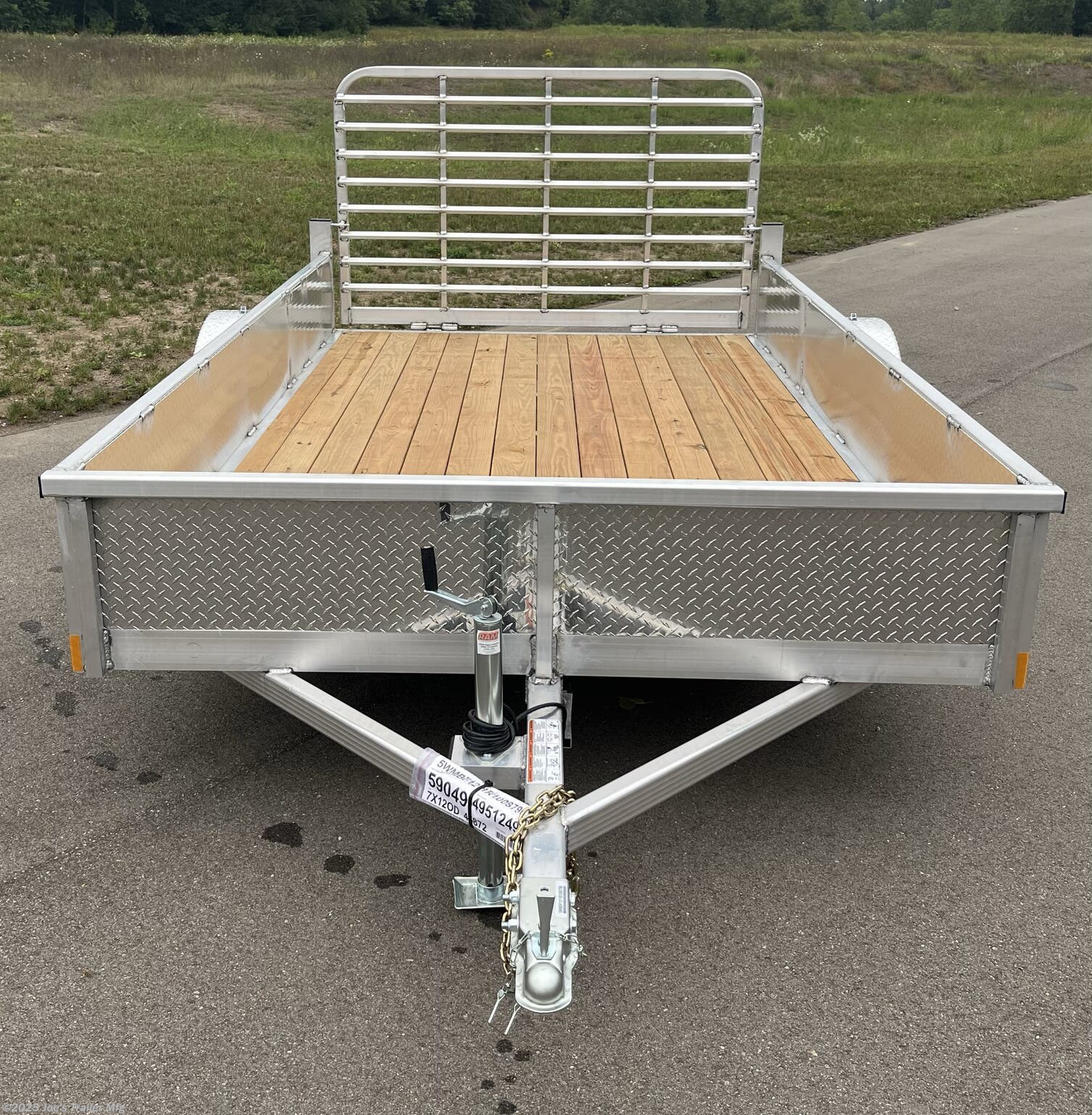 Legend Open Deluxe 7X12 Utility Trailer, 4" Tube Main Frame Utility Trailer, 24" OC Crossmembers Trailer, 15" Side Rails With Skirting, 2" Coupler Trailer, ST205/75R14 Steel Tires Trailer, ATP Fenders Utility Trailer, Treated Wood Decking Trailer, (4) Stake Pockets Utility Trailer, No Brakes Utility Trailer, Load Angle 19° Trailer, Ramp Length 48" Trailer, Ramp Pivot Point Trailer, Heavy Duty Utility Trailer, Durable Utility Trailer, Steel Tires Utility Trailer, Tubular Frame Trailer, Crossmembers Spacing 24" Trailer, Side Rails With Skirting Utility Trailer, Coupler 2" Trailer, Aluminum Fenders Utility Trailer, Wood Decking Treated, Stake Pockets 4 Trailer, Trailer Without Brakes, Load Angle 19 Degrees, Ramp Length 48 Inches, Utility Trailer Specs, Trailer Features, Utility Trailer Specifications, Legend Trailer Features, Deluxe Utility Trailer, Open Utility Trailer