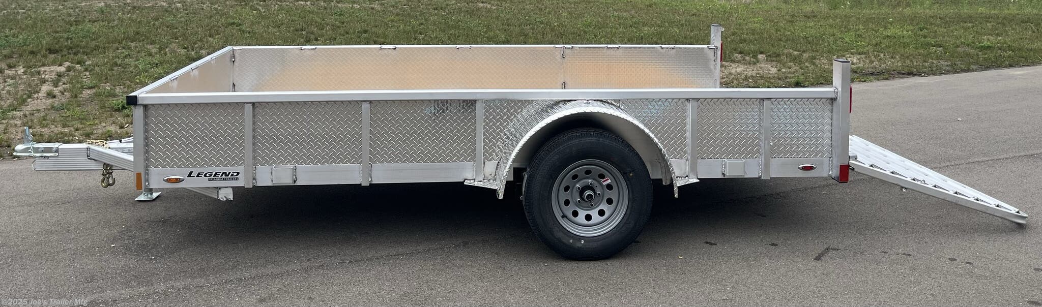 Legend Open Deluxe 7X12 Utility Trailer, 4" Tube Main Frame Utility Trailer, 24" OC Crossmembers Trailer, 15" Side Rails With Skirting, 2" Coupler Trailer, ST205/75R14 Steel Tires Trailer, ATP Fenders Utility Trailer, Treated Wood Decking Trailer, (4) Stake Pockets Utility Trailer, No Brakes Utility Trailer, Load Angle 19° Trailer, Ramp Length 48" Trailer, Ramp Pivot Point Trailer, Heavy Duty Utility Trailer, Durable Utility Trailer, Steel Tires Utility Trailer, Tubular Frame Trailer, Crossmembers Spacing 24" Trailer, Side Rails With Skirting Utility Trailer, Coupler 2" Trailer, Aluminum Fenders Utility Trailer, Wood Decking Treated, Stake Pockets 4 Trailer, Trailer Without Brakes, Load Angle 19 Degrees, Ramp Length 48 Inches, Utility Trailer Specs, Trailer Features, Utility Trailer Specifications, Legend Trailer Features, Deluxe Utility Trailer, Open Utility Trailer