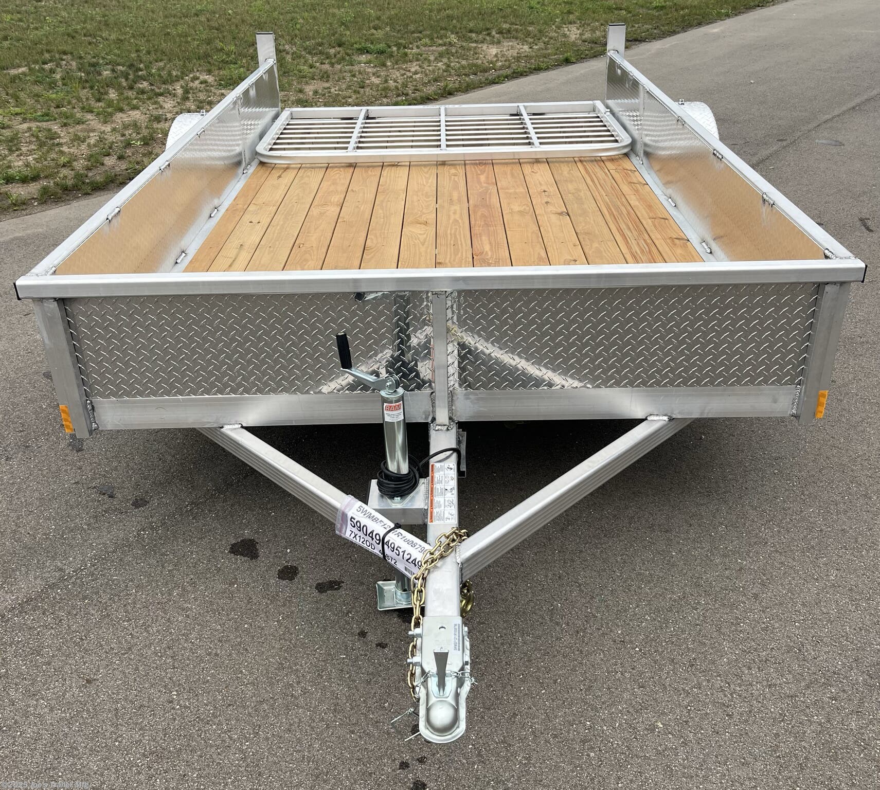 Legend Open Deluxe 7X12 Utility Trailer, 4" Tube Main Frame Utility Trailer, 24" OC Crossmembers Trailer, 15" Side Rails With Skirting, 2" Coupler Trailer, ST205/75R14 Steel Tires Trailer, ATP Fenders Utility Trailer, Treated Wood Decking Trailer, (4) Stake Pockets Utility Trailer, No Brakes Utility Trailer, Load Angle 19° Trailer, Ramp Length 48" Trailer, Ramp Pivot Point Trailer, Heavy Duty Utility Trailer, Durable Utility Trailer, Steel Tires Utility Trailer, Tubular Frame Trailer, Crossmembers Spacing 24" Trailer, Side Rails With Skirting Utility Trailer, Coupler 2" Trailer, Aluminum Fenders Utility Trailer, Wood Decking Treated, Stake Pockets 4 Trailer, Trailer Without Brakes, Load Angle 19 Degrees, Ramp Length 48 Inches, Utility Trailer Specs, Trailer Features, Utility Trailer Specifications, Legend Trailer Features, Deluxe Utility Trailer, Open Utility Trailer