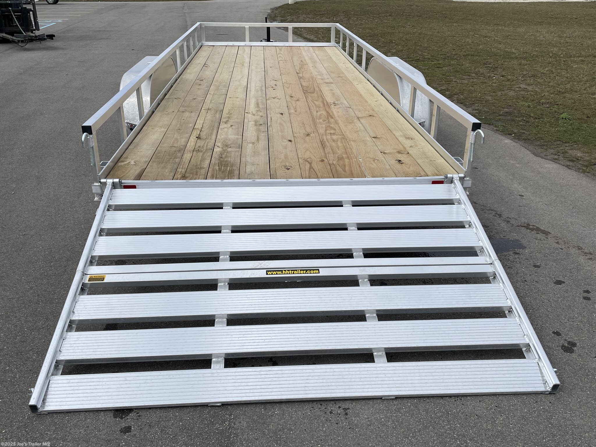 Aluminum Rail Side Trailer H8220TRSA H&H Aluminum Rail Side Utility Trailer, 3" x 2" Aluminum Angle Extrusion Frame, 3" Aluminum Channel Crossmembers, Tandem Axle Utility Trailer, 5" Aluminum Triple Tube Tongue, 2" x 1-1/2" Aluminum Extrusion Tube Uprights, 2" x 2" Aluminum Tube Top Rail, 2-5/16" A-Frame Posi-Lock Coupler, Dual Safety Chains and Hooks, 7-Way RV-Style Plug, Sealed Wiring Harness, 2k Rated Setback Jack, 54" Aluminum Bi-Fold Gate, Aluminum Teardrop Fenders, Tandem Spring Brake Suspension, 7000 lb GVWR Tandem Axle, Easy Lube Hubs, ST205/75R15 'C' Tires, 15" Aluminum Wheels, 2 x 8 Pressure Treated Pine Decking, Front & Rear End Board Caps, Aluminum Stake Pockets, Full LED DOT Compliant Lighting, Load Angle, Ramp Length, Load Angle 17°, Ramp Length 58", Aluminum Utility Trailer Features, Heavy-Duty Aluminum Trailer, Lightweight Aluminum Trailer, Durable Aluminum Utility Trailer, High-Performance Utility Trailer, H&H Aluminum Utility Trailer, Tandem Axle Trailer, Utility Trai