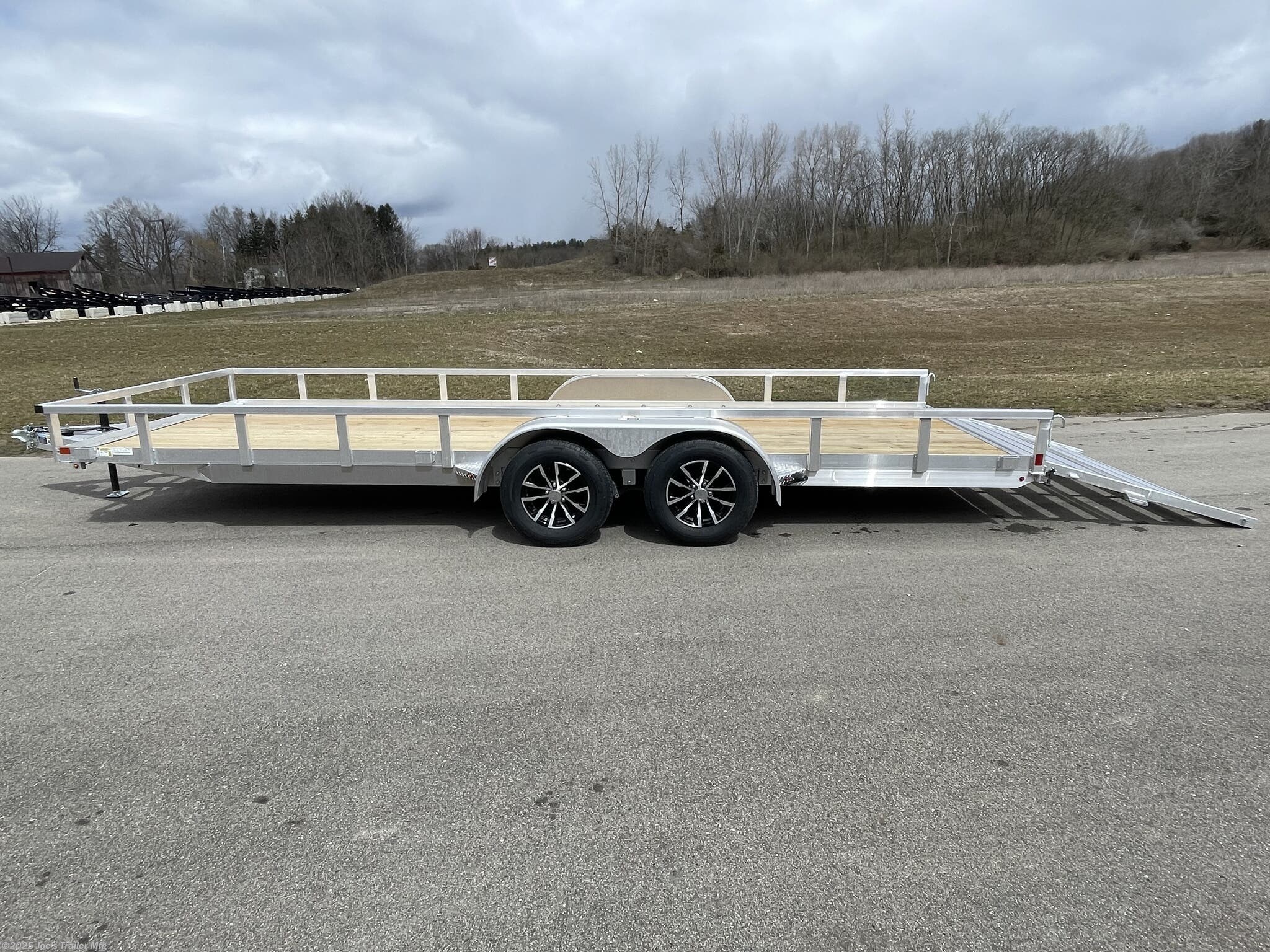Rail Side Trailer H8220TRSA H&H Aluminum Rail Side Utility Trailer, 3" x 2" Aluminum Angle Extrusion Frame, 3" Aluminum Channel Crossmembers, Tandem Axle Utility Trailer, 5" Aluminum Triple Tube Tongue, 2" x 1-1/2" Aluminum Extrusion Tube Uprights, 2" x 2" Aluminum Tube Top Rail, 2-5/16" A-Frame Posi-Lock Coupler, Dual Safety Chains and Hooks, 7-Way RV-Style Plug, Sealed Wiring Harness, 2k Rated Setback Jack, 54" Aluminum Bi-Fold Gate, Aluminum Teardrop Fenders, Tandem Spring Brake Suspension, 7000 lb GVWR Tandem Axle, Easy Lube Hubs, ST205/75R15 'C' Tires, 15" Aluminum Wheels, 2 x 8 Pressure Treated Pine Decking, Front & Rear End Board Caps, Aluminum Stake Pockets, Full LED DOT Compliant Lighting, Load Angle, Ramp Length, Load Angle 17°, Ramp Length 58", Aluminum Utility Trailer Features, Heavy-Duty Aluminum Trailer, Lightweight Aluminum Trailer, Durable Aluminum Utility Trailer, High-Performance Utility Trailer, H&H Aluminum Utility Trailer, Tandem Axle Trailer, Utility Trailer with