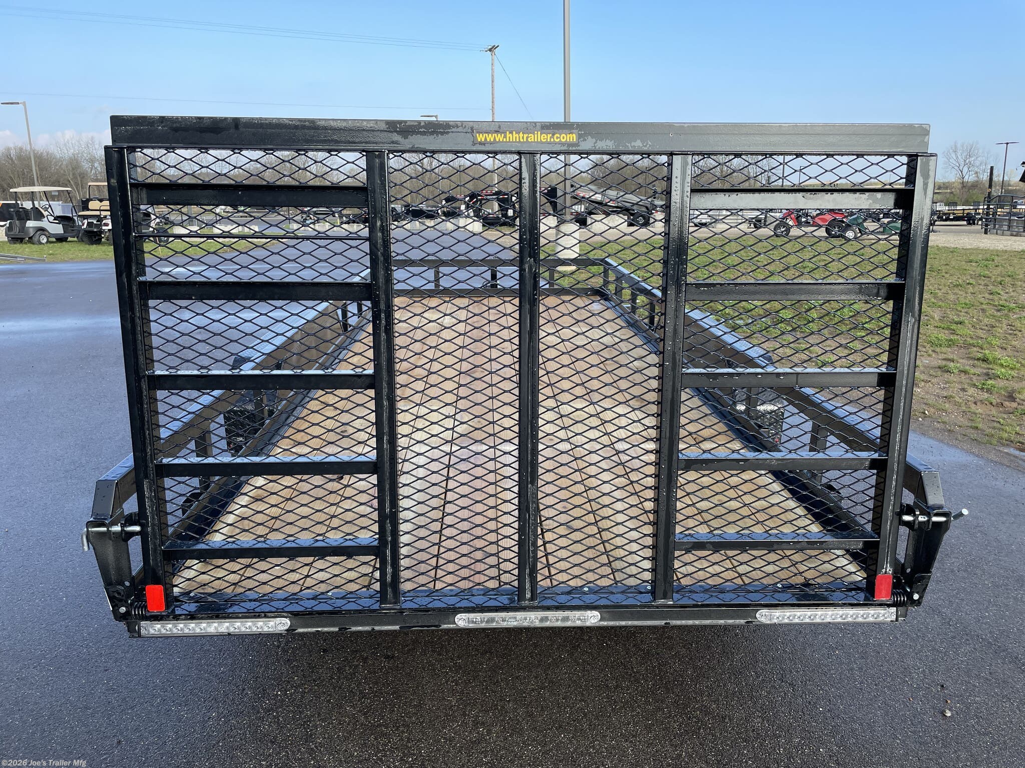 H&H 82" x 18' Heavy Duty Landscape/Utility Trailer, 5" x 3" x 1/4" Steel Angle Frame, 3" x 2" x 3/16" Steel Angle Crossmembers, 5" Steel Channel Tongue, Fully Wrapped, 3" x 2" Steel Tube Top Rail, 2-5/16" A-Frame Posi-Lock Coupler, Dual Safety Chains and Hooks, 7-Way RV-Style Plug, Enclosed Sealed Wiring Harness, 7k Rated Setback Drop Leg Jack, 50" Tall Reinforced Spring Assist Gate, Ladder Style Gate, Steel Formed Tread Plate Fenders, Tandem Spring Brake Suspension, 9900 lb GVWR, Easy Lube Hubs, ST225/75R15 'D' Tires, 15" Black Steel Wheels, Industrial Grade Polymer Finish, 2 x 8 Pressure Treated Pine Decking, Welded Front Board Retainer, Rear End Board Cap, Stake Pockets, Spare Tire Mount, Full LED DOT Compliant Lighting, Heavy Duty Landscape Trailer, Utility Trailer with Steel Frame, Steel Angle Crossmembers Trailer, Heavy Duty Trailer with Spring Assist Gate, Tandem Brake Suspension Trailer, Pressure Treated Pine Deck Utility Trailer, Steel Tube Top Rail Trailer, DOT Compliant Trai