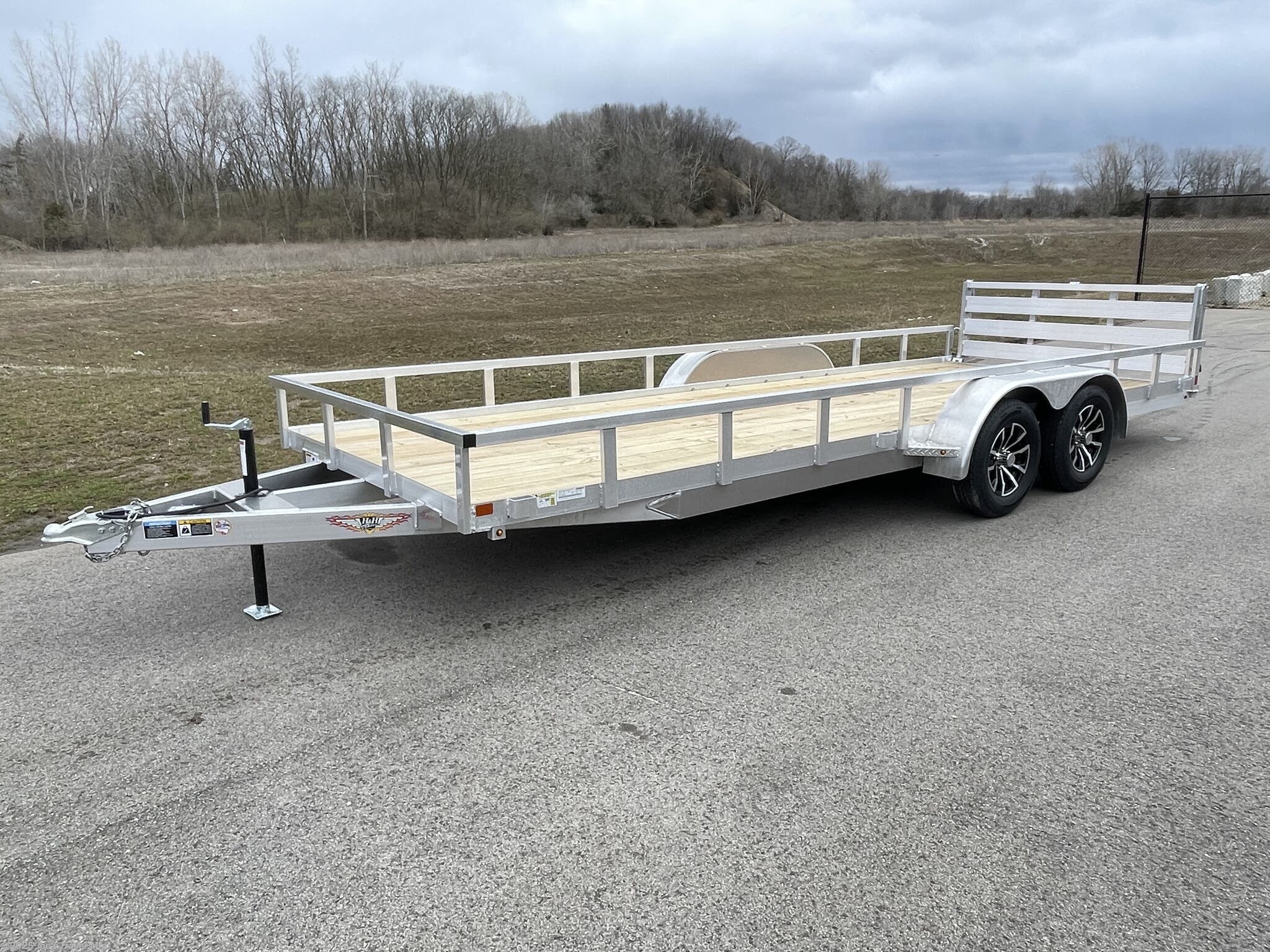 Landscape Trailer H8218TRSA H&H Aluminum Rail Side Utility, aluminum angle extrusion frame, 3" x 2" aluminum frame, 3" aluminum channel crossmembers, tandem axle trailer, 5" aluminum triple tube tongue, 2" x 1-1/2" aluminum uprights, 2" x 2" aluminum top rail, 2-5/16" A-Frame posi-lock coupler, dual safety chains and hooks, 7-way RV-style plug, sealed wiring harness, 2k rated setback jack, 54" aluminum bi-fold gate, aluminum teardrop fenders, tandem spring brake suspension, 7000 lb GVWR, easy lube hubs, ST205/75R15 C tires, 15" aluminum wheels, 2 x 8 pressure treated pine decking, front and rear end board caps, aluminum stake pockets, full LED DOT compliant lighting, load angle and ramp length, 17° load angle, 58" ramp length, ramp pivot point, aluminum utility trailer, H&H utility trailer, aluminum rail side trailer, aluminum trailer with stake pockets, tandem axle utility trailer, aluminum deck trailer, aluminum fender trailer, DOT compliant utility trailer, aluminum utility trailer