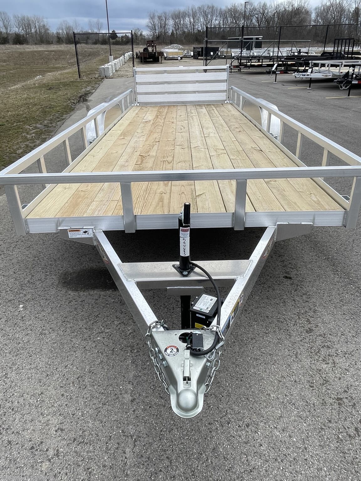 Bumper Pull Rail Side H8218TRSA H&H Aluminum Rail Side Utility, aluminum angle extrusion frame, 3" x 2" aluminum frame, 3" aluminum channel crossmembers, tandem axle trailer, 5" aluminum triple tube tongue, 2" x 1-1/2" aluminum uprights, 2" x 2" aluminum top rail, 2-5/16" A-Frame posi-lock coupler, dual safety chains and hooks, 7-way RV-style plug, sealed wiring harness, 2k rated setback jack, 54" aluminum bi-fold gate, aluminum teardrop fenders, tandem spring brake suspension, 7000 lb GVWR, easy lube hubs, ST205/75R15 C tires, 15" aluminum wheels, 2 x 8 pressure treated pine decking, front and rear end board caps, aluminum stake pockets, full LED DOT compliant lighting, load angle and ramp length, 17° load angle, 58" ramp length, ramp pivot point, aluminum utility trailer, H&H utility trailer, aluminum rail side trailer, aluminum trailer with stake pockets, tandem axle utility trailer, aluminum deck trailer, aluminum fender trailer, DOT compliant utility trailer, aluminum utility trai