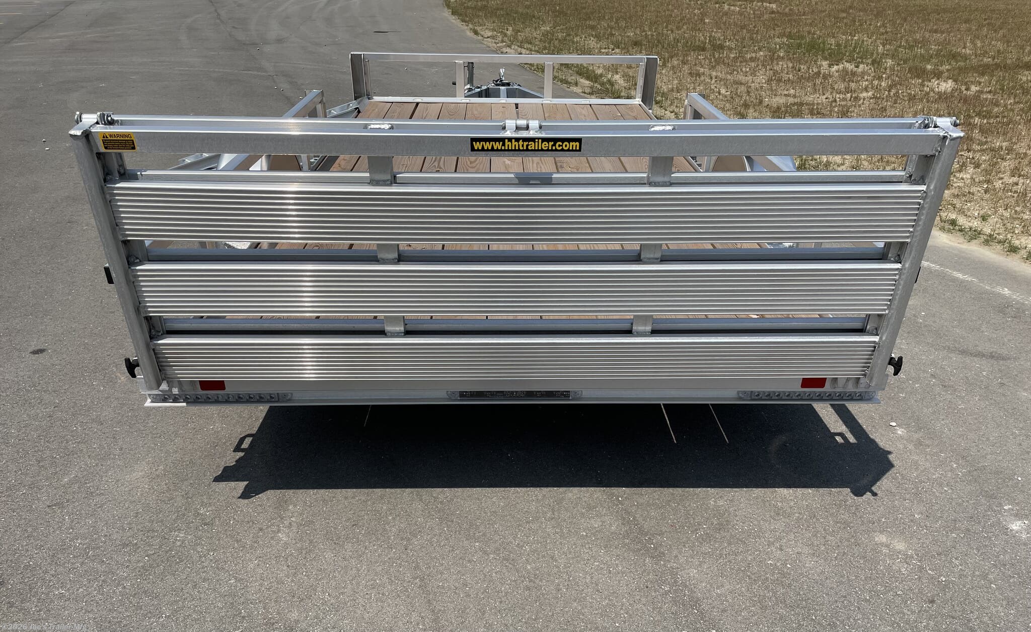 H&H 82"X14' Single Axle Utility Trailer, H&H trailer, single axle utility trailer, 82"X14' trailer, utility trailer, 3"x2" angle cross members, angle cross members, 3"x2" angle frame, angle frame, 2" A frame tongue, A frame tongue, 17.5" deck height, deck height, 1K swivel jack, swivel jack, 3K spring axle, spring axle, 15" radial load range C aluminum wheels, radial load range C wheels, aluminum wheels, ST205/75R15 wheels, LED lighting, LED trailer lights, pressure treated pine decking, pine decking, bi-fold gate, bi-fold ramp, removable side mounted ramps, side mounted ramps, trailer ramps, H&H trailer features, H&H trailer specifications, utility trailer features, utility trailer specifications, single axle trailer benefits, durable trailer, reliable utility trailer, trailer with LED lights, trailer with aluminum wheels, trailer with pressure treated decking, trailer with bi-fold gate, trailer with removable ramps.