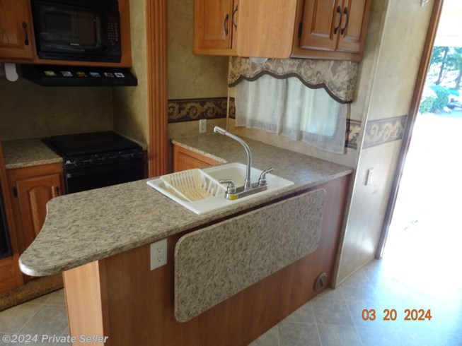 Kitchen dual sinks, lots of counter and storage space. additional drop-leaf counter top.