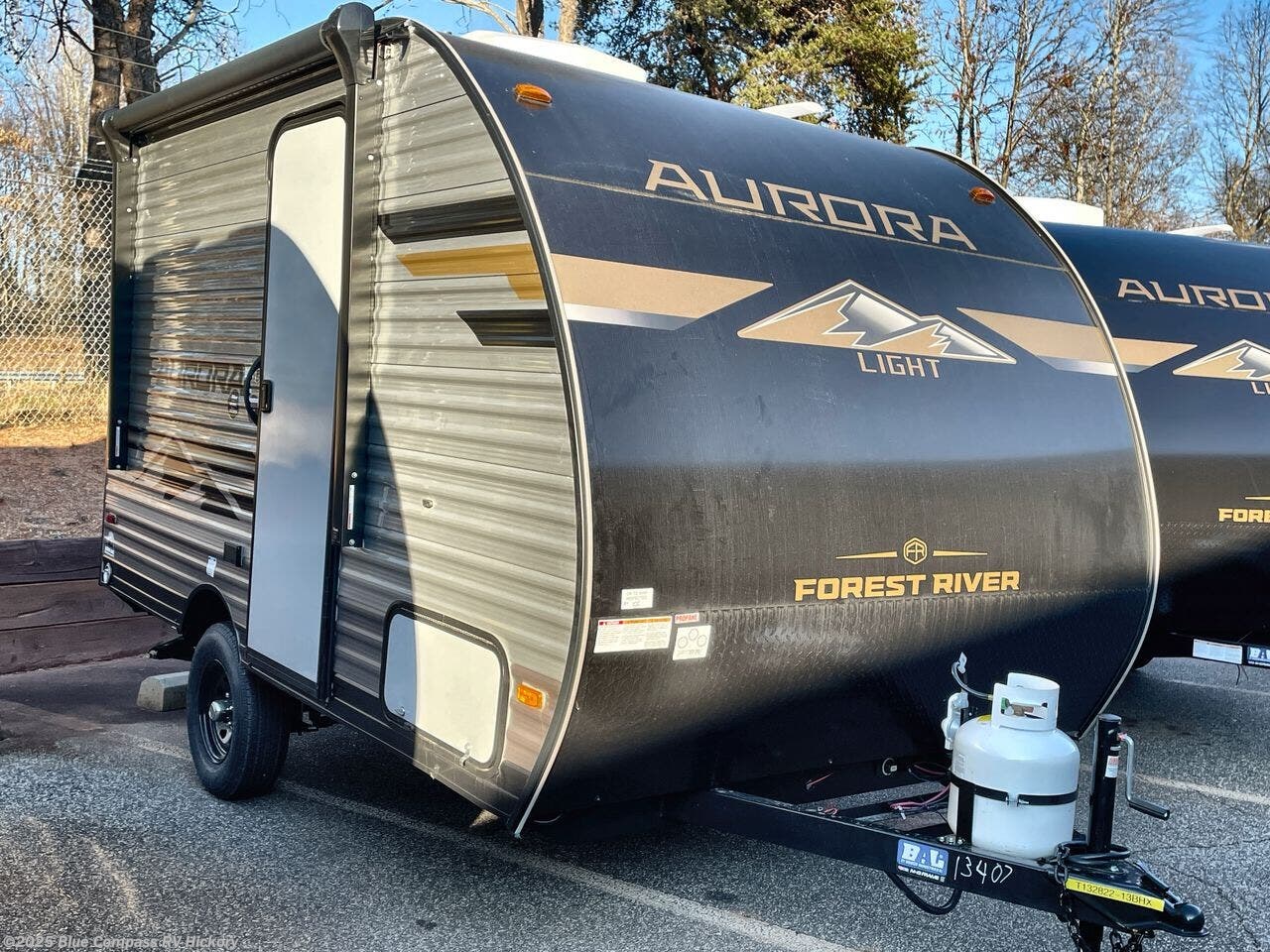 Contact us now about this 2026 Forest River Aurora Light 13RKX! 2026 Aurora Light 13RKX by Forest River from Blue Compass RV Hickory in Claremont, North Carolina
