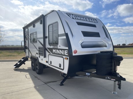 &lt;p&gt;Introducing the 2024 Winnebago Micro Minnie 1821FBS, a compact and versatile travel trailer that redefines the art of on-the-go living. This lightweight wonder is designed for adventurers who seek the perfect balance between functionality and comfort. With its thoughtful layout and modern amenities, the Micro Minnie 1821FBS offers a delightful travel experience for couples or small families.&lt;/p&gt;
&lt;p&gt;Measuring at just the right size, the 1821FBS combines nimble towing with a surprisingly spacious interior. The exterior showcases Winnebago&#39;s commitment to durability and aerodynamic design, making it easy to maneuver on the open road. Its sleek profile is complemented by stylish graphics and premium finishes, ensuring that you travel in both style and substance.&lt;/p&gt;
&lt;p&gt;Step inside, and you&#39;ll be greeted by a smartly designed living space that maximizes every inch. The open floor plan seamlessly integrates the kitchen, dining, and living areas, creating a welcoming atmosphere for socializing or relaxation. The kitchen is equipped with modern appliances, ample storage, and a functional workspace, allowing you to prepare delicious meals on the go.&lt;/p&gt;
&lt;p&gt;The cozy sleeping quarters feature a comfortable bed and clever storage solutions, making the most of the available space. The bathroom is both efficient and stylish, featuring a shower, toilet, and vanity with all the comforts of home. Large windows throughout the trailer provide natural light and panoramic views, connecting you with the beauty of your surroundings.&lt;/p&gt;
&lt;p&gt;The 1821FBS is equipped with cutting-edge technology to enhance your travel experience. From entertainment systems to climate control, Winnebago has integrated the latest features to keep you connected and comfortable. The trailer&#39;s energy-efficient design and eco-friendly components contribute to a sustainable and responsible travel lifestyle.&lt;/p&gt;
&lt;p&gt;Whether you&#39;re embarking on a weekend getaway or an extended road trip, the 2024 Winnebago Micro Minnie 1821FBS is your ticket to adventure. Compact, stylish, and brimming with thoughtful features, this travel trailer is poised to be the ideal companion for those who crave the freedom of the open road without compromising on the comforts of home.&lt;/p&gt;
